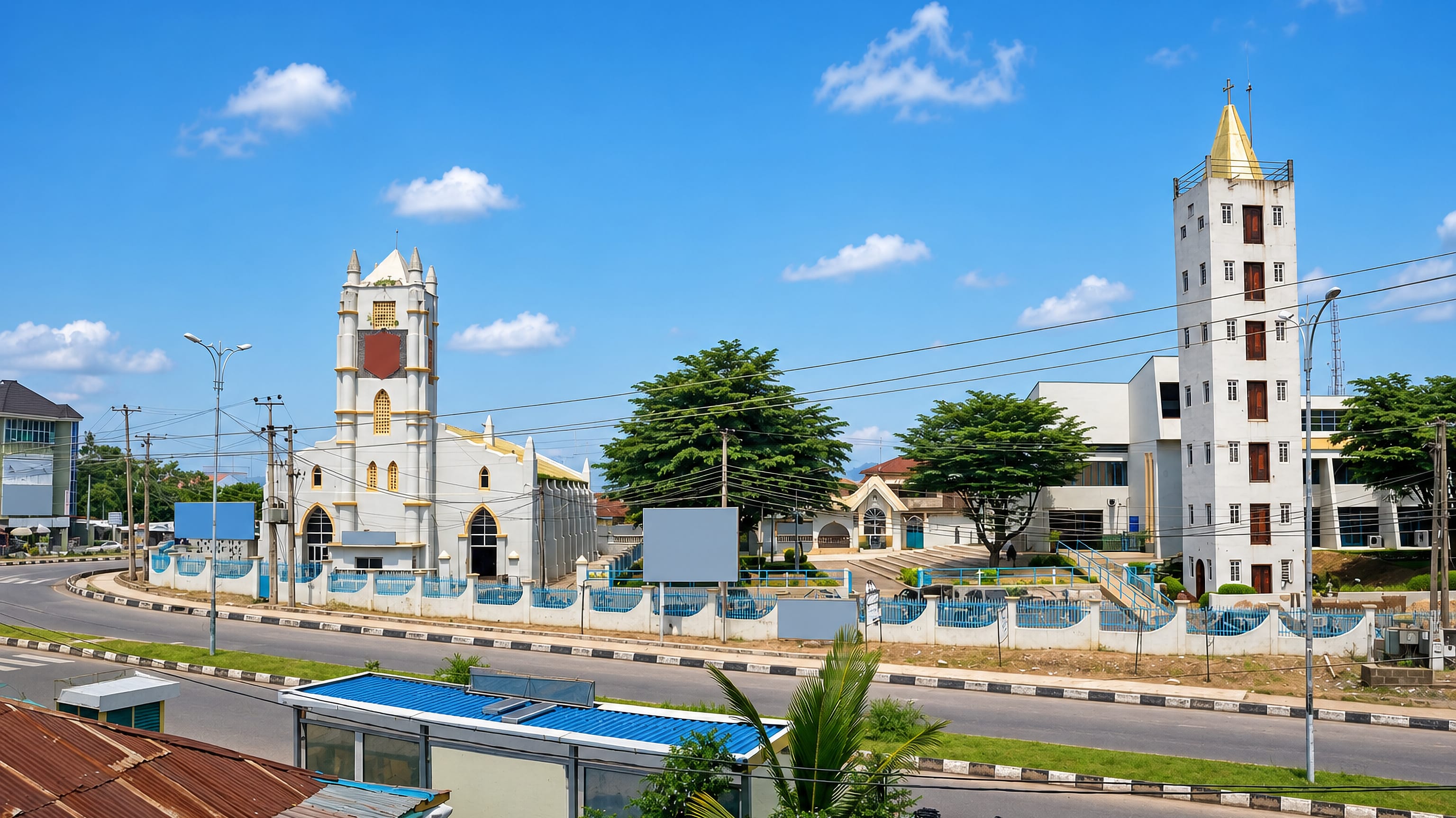 Churches and low-rise buildings along a wide roadside in Abeokuta, Ogun State, Nigeria