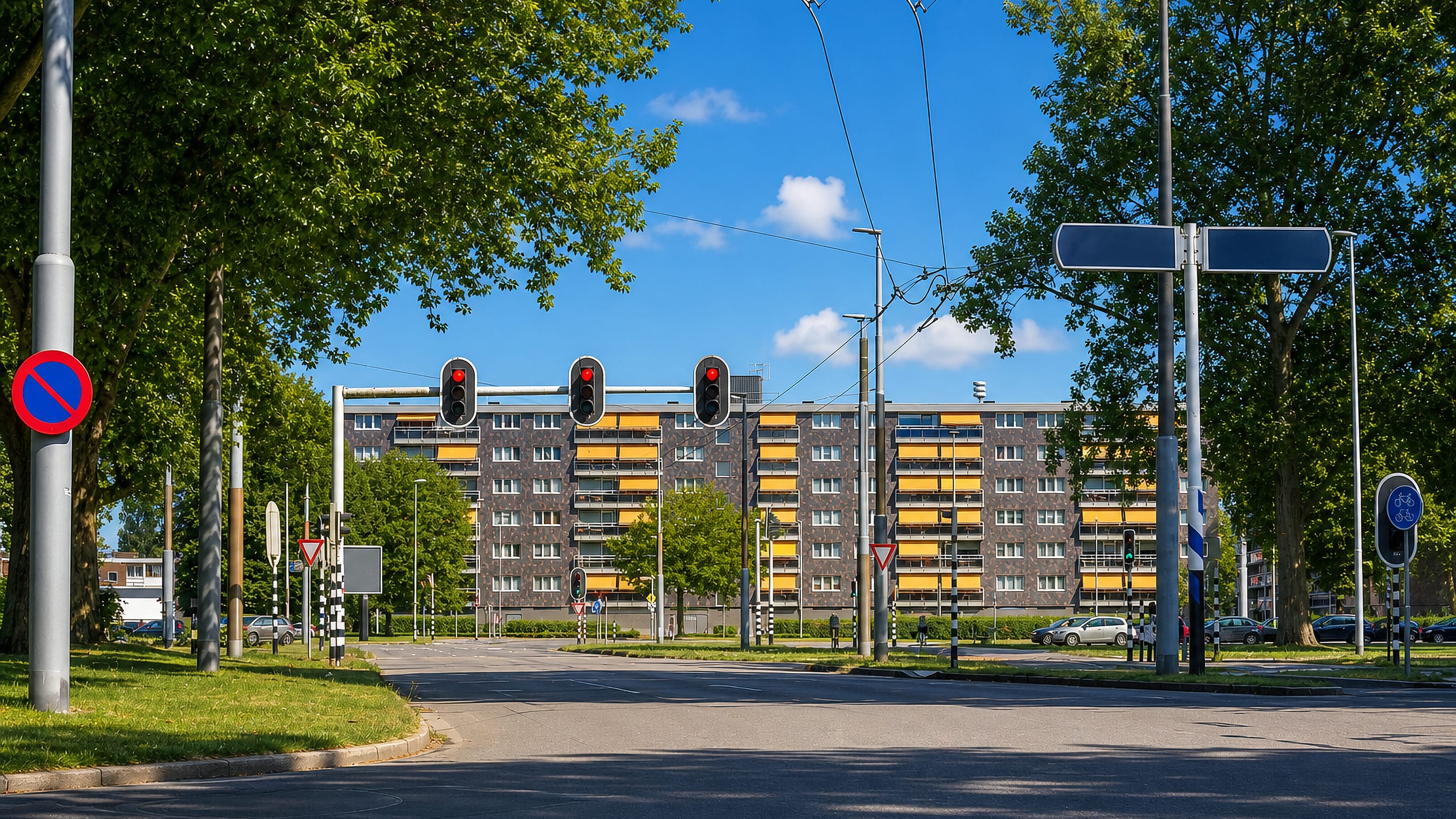 Trolleybus wires cross a road junction before a yellow-panelled apartment block in Malburgen West, Arnhem.