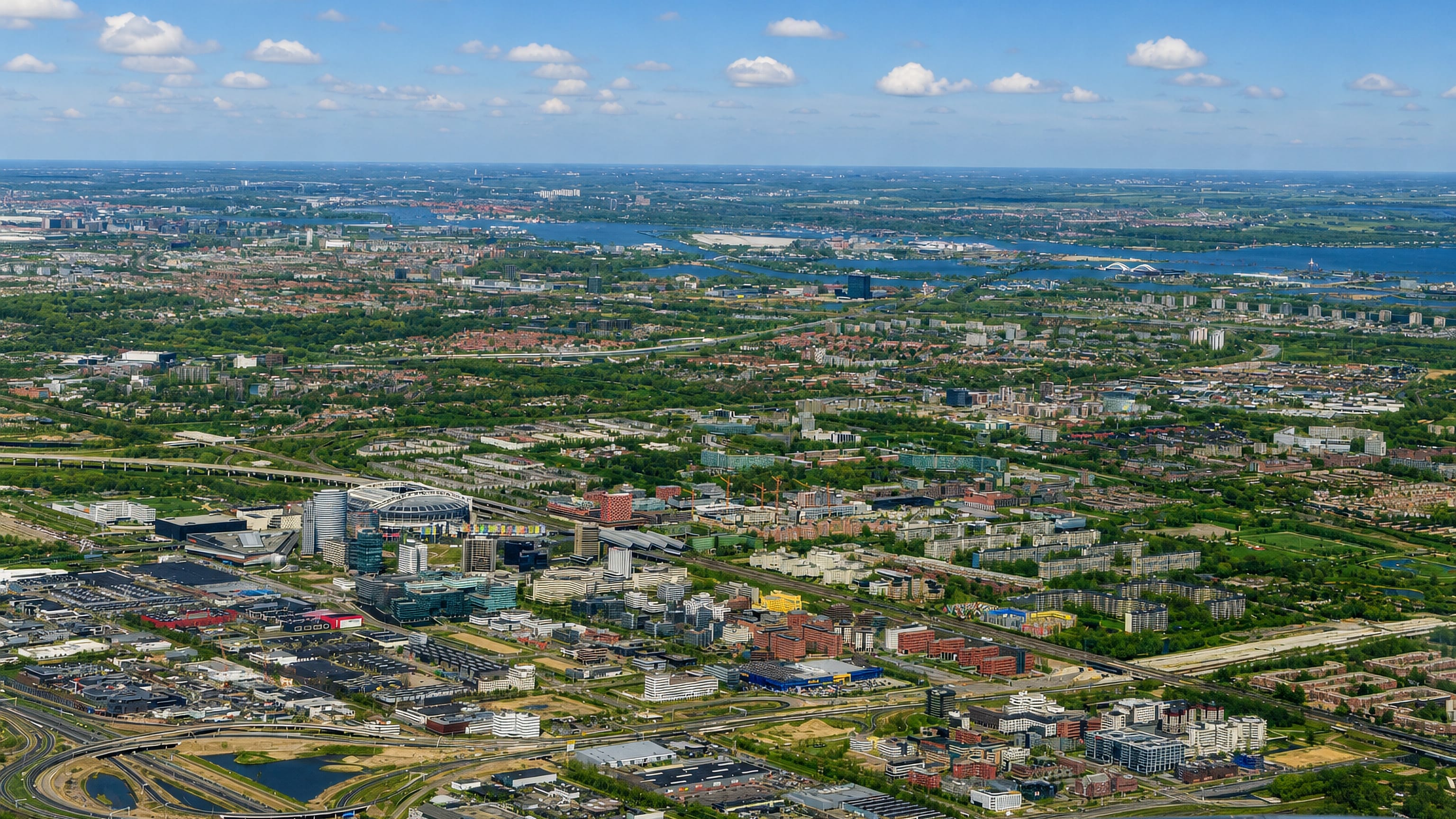 Aerial over Amsterdam-Zuidoost with the Johan Cruijff ArenA and the Bijlmer high-rises