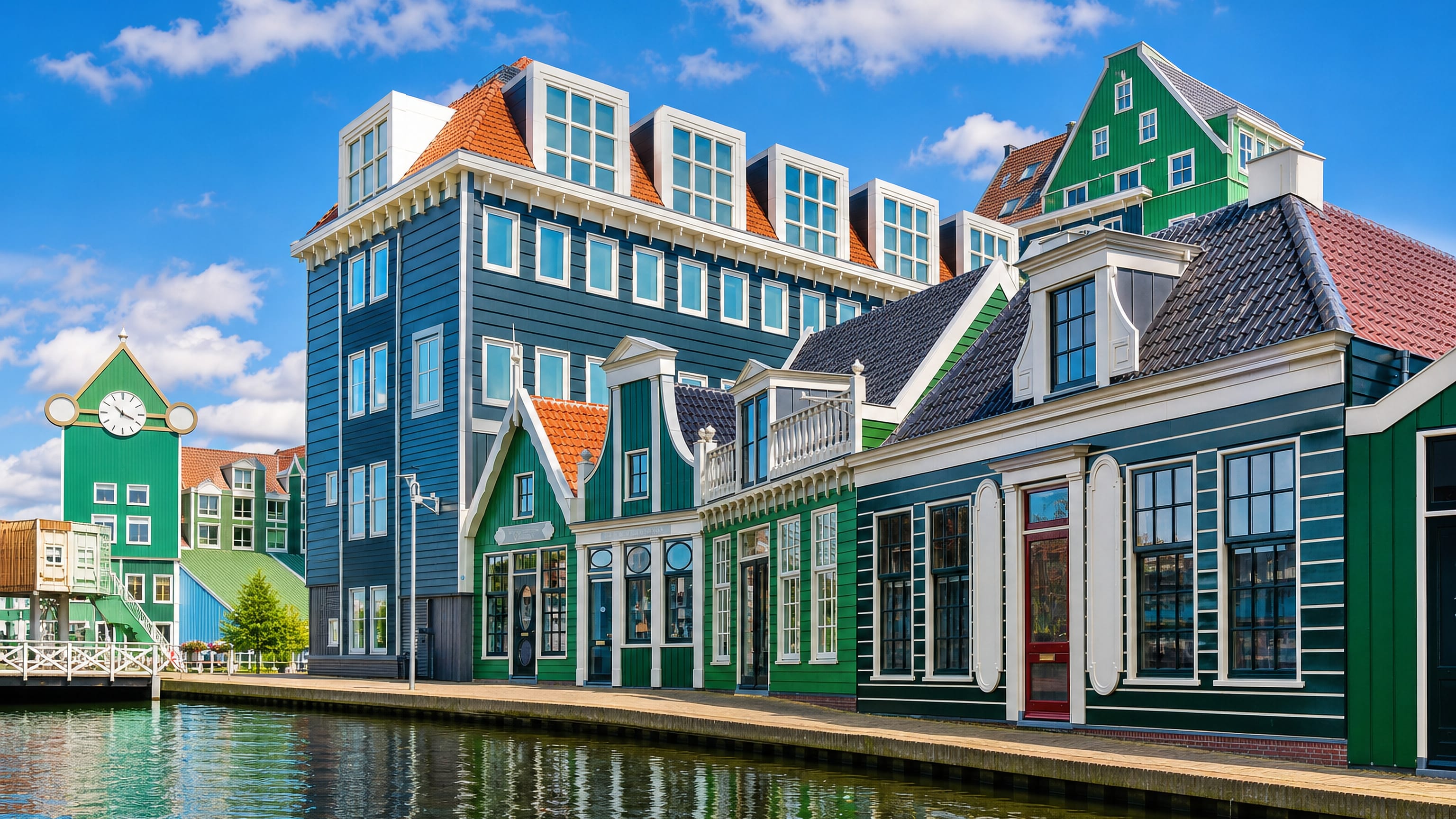 Green and blue Zaanse timber facades and a clock tower mirrored in the water at Zaandam, Netherlands.