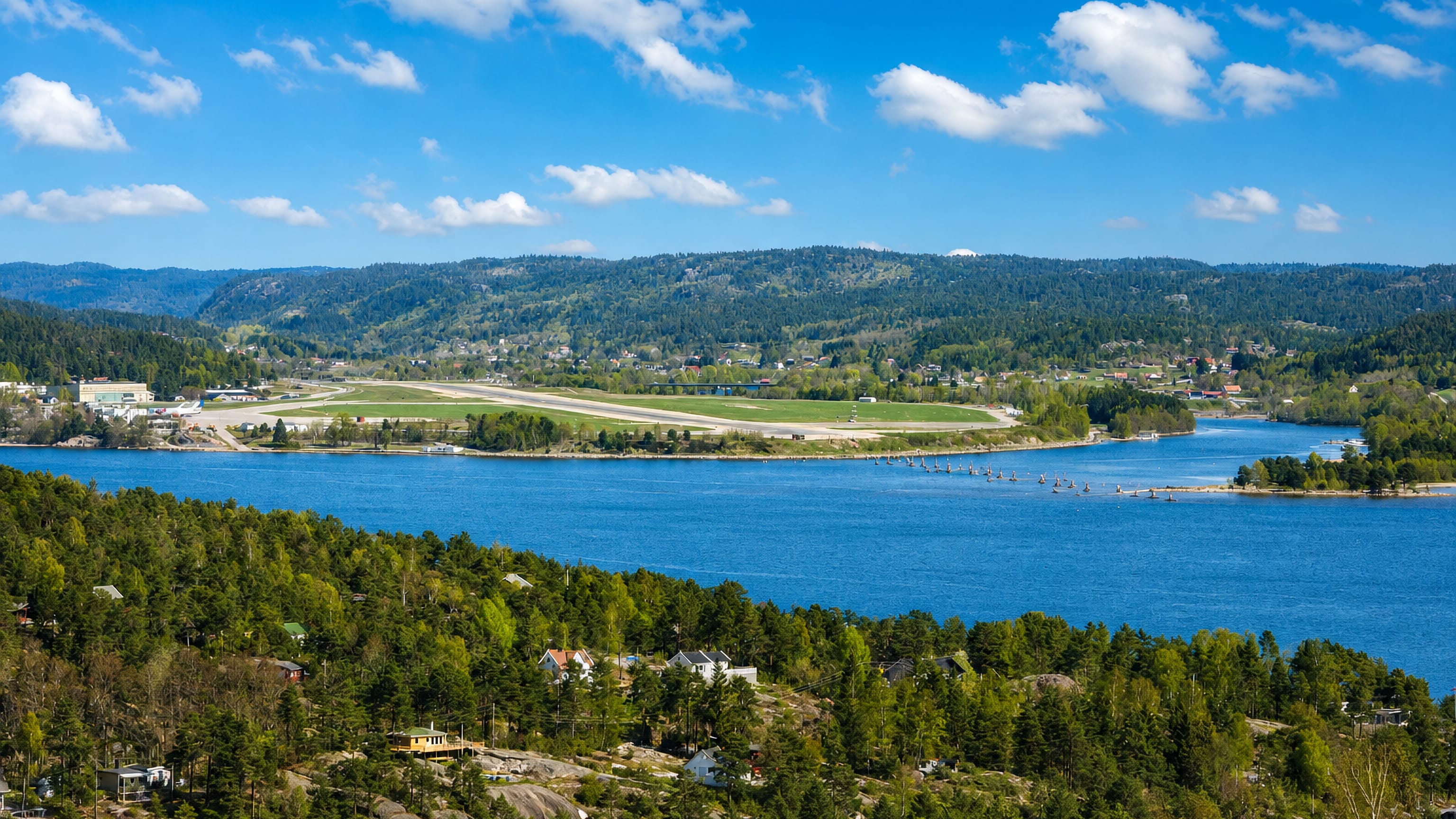 Topdalsfjord and the Kjevik airport runway seen from wooded hills in Tveit, Kristiansand.