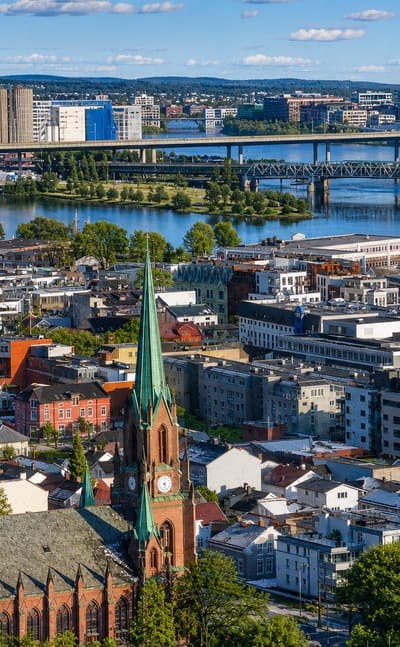 Aerial view over Bragernes, Drammen, with the green-spired Bragernes Church above the townscape and the Drammen River bridges beyond.