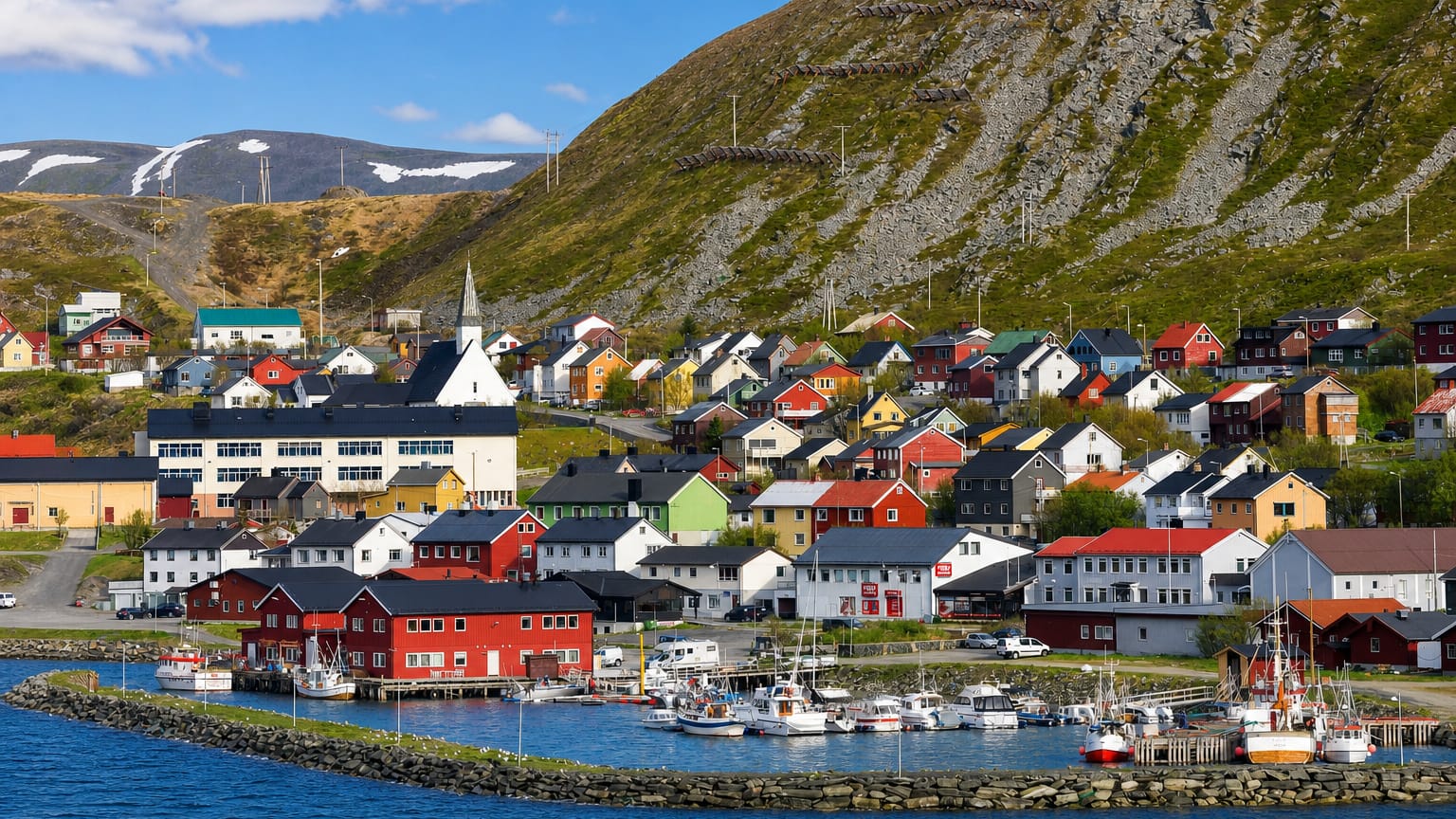 Kjøllefjord, Norway, a colourful Arctic fishing village and harbour below a bare Finnmark mountain.
