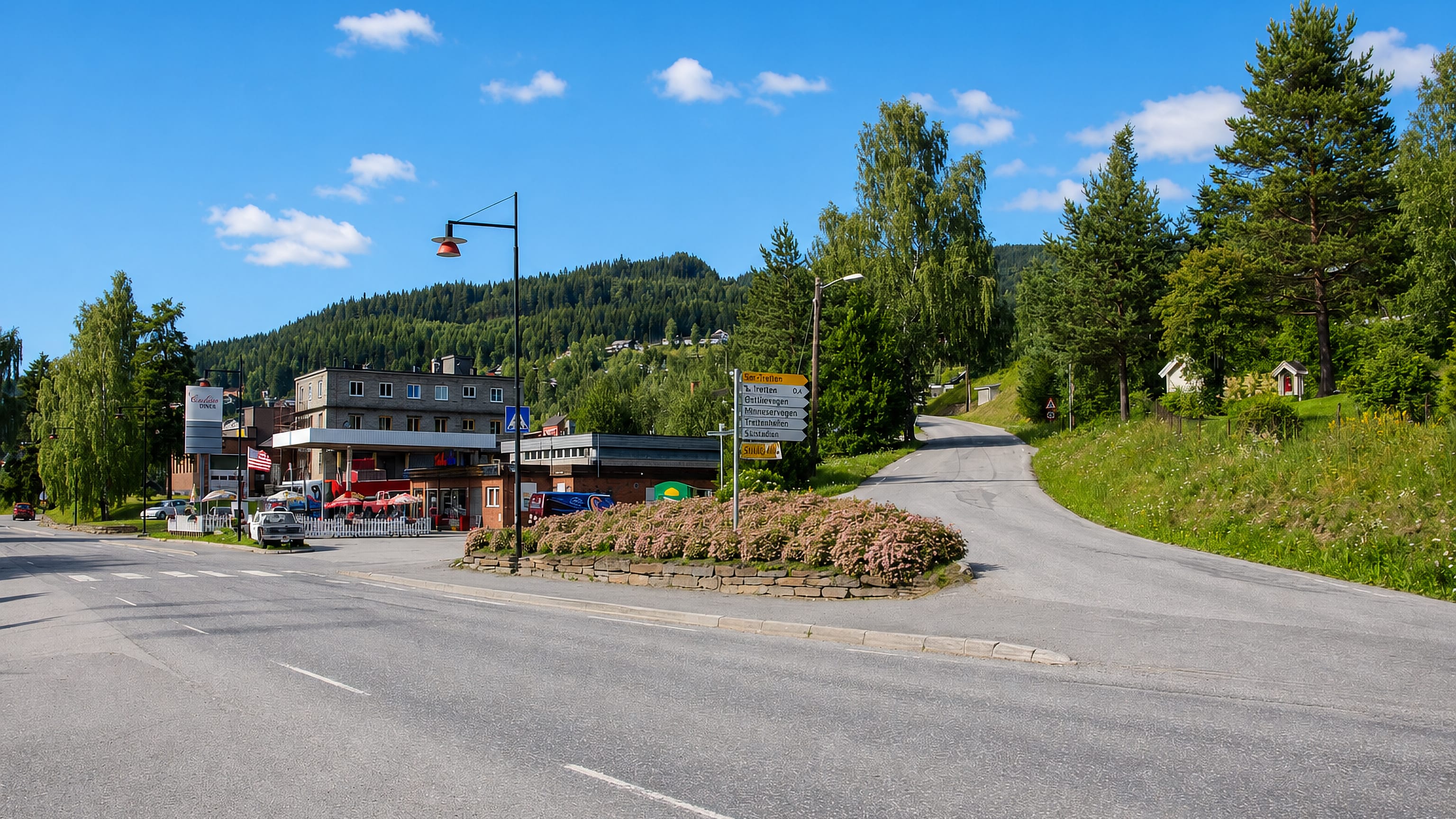 Tretten, Norway, a village road junction with signposts and shops below forested Gudbrandsdalen hills.