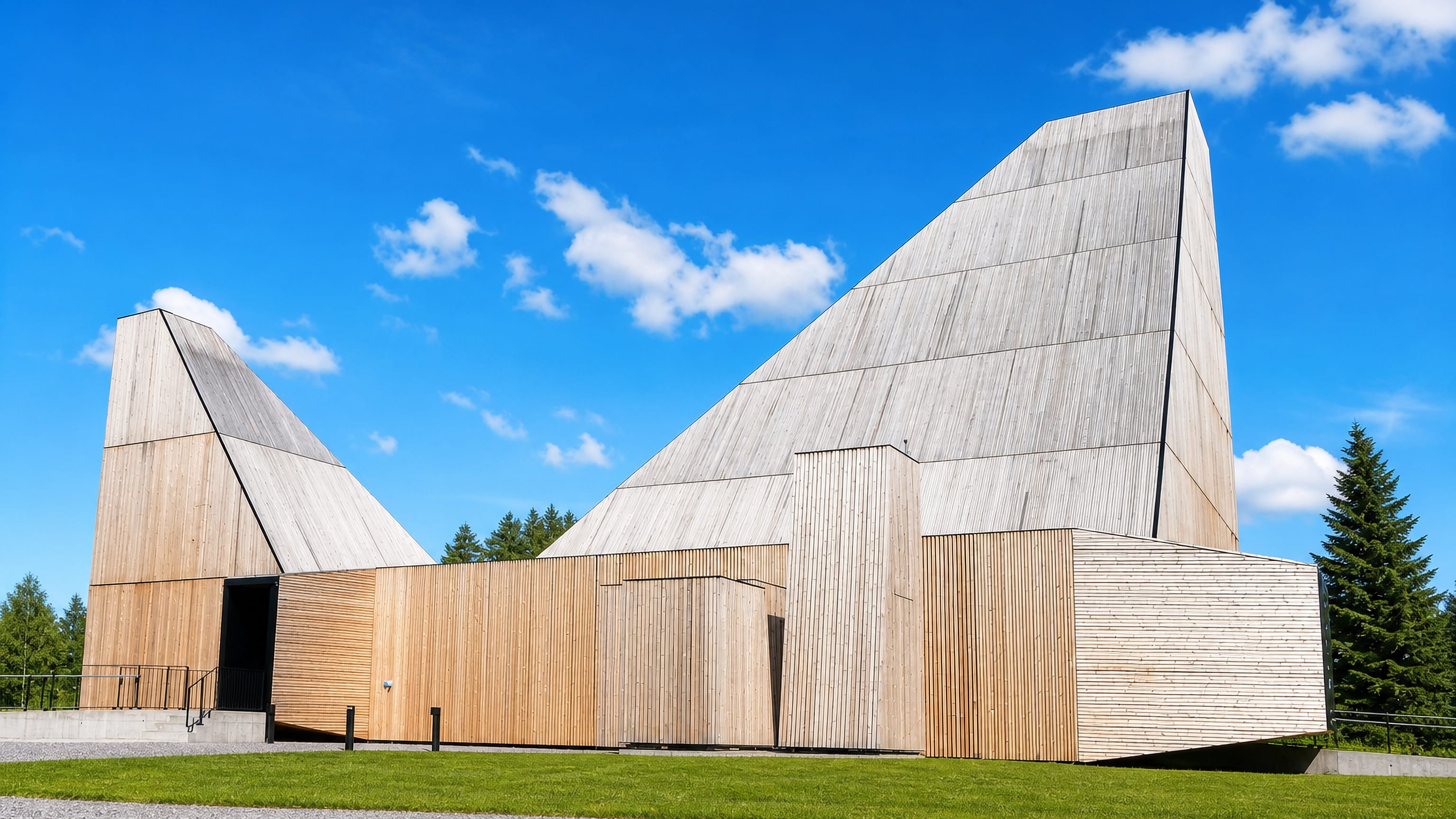 Våler's contemporary timber church with two soaring angular peaks clad in pale wood against a bright blue sky.