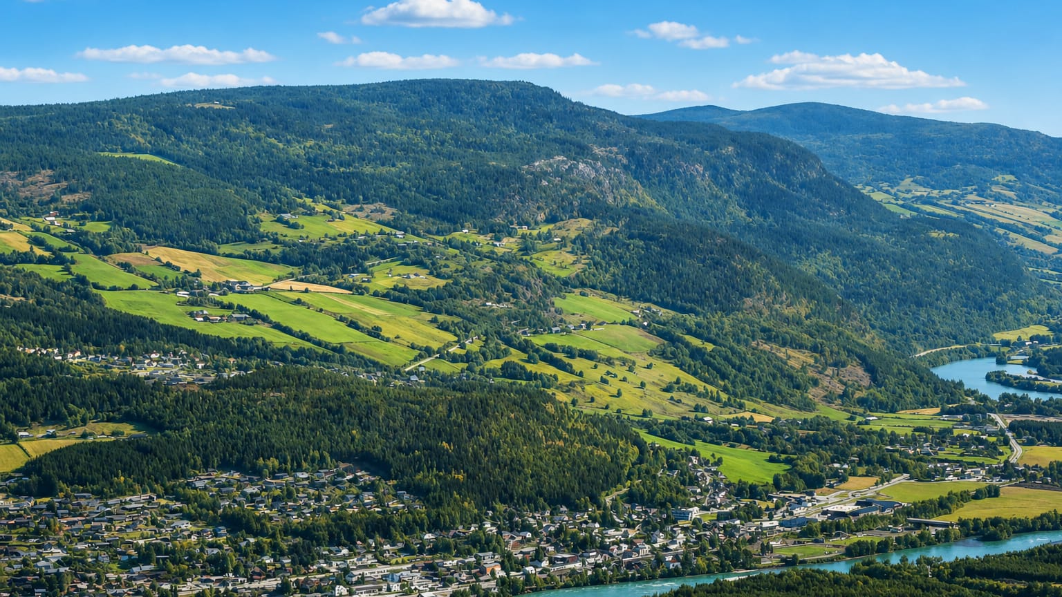 Aerial view of Vinstra, Norway, in the Gudbrandsdalen valley beside its river and green farmland