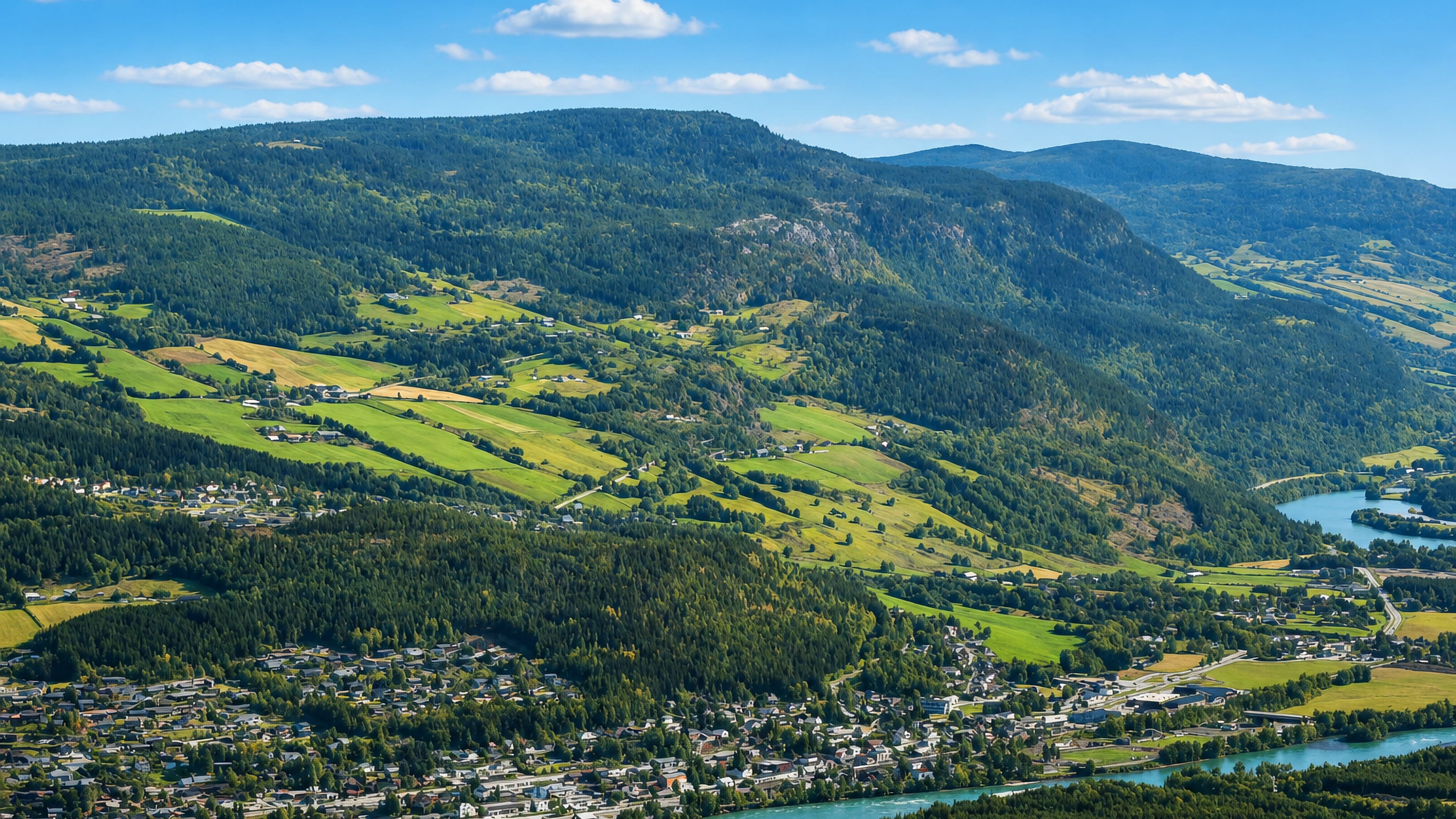 Aerial view of Vinstra, Norway, in the Gudbrandsdalen valley beside its river and green farmland