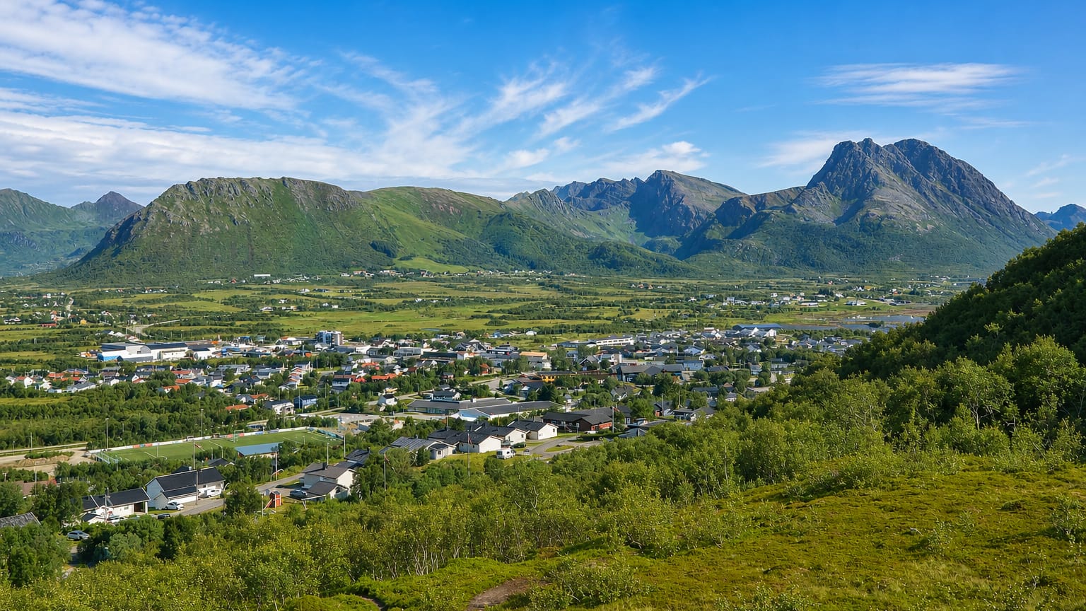 Elevated view of Myre town set below the dramatic Vesterålen mountains, Norway