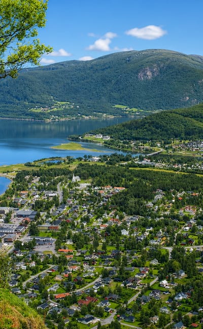 View over Rognan, Norway, at the head of a fjord ringed by green valleys and mountains