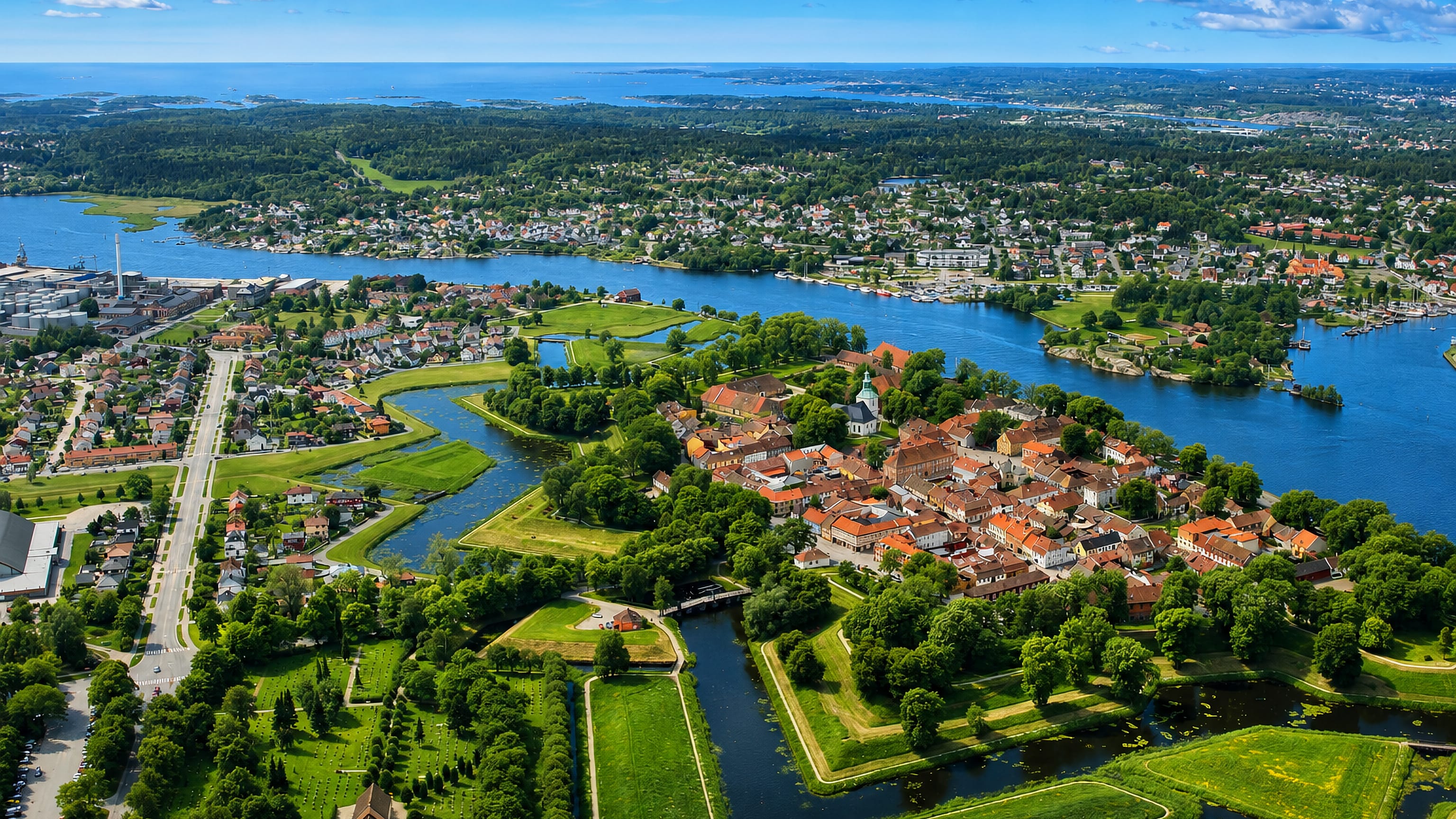 Aerial view of Fredrikstad's star-shaped Gamlebyen fortress town, its ramparts, moats and red-roofed streets.