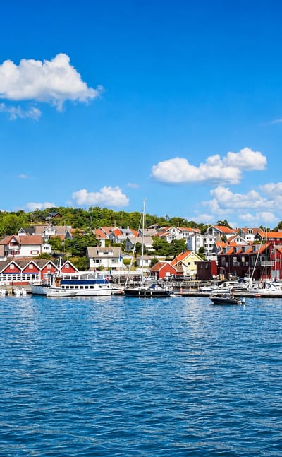 Red harbour houses and moored boats at Skjaerhalden, Norway, on the Hvaler archipelago