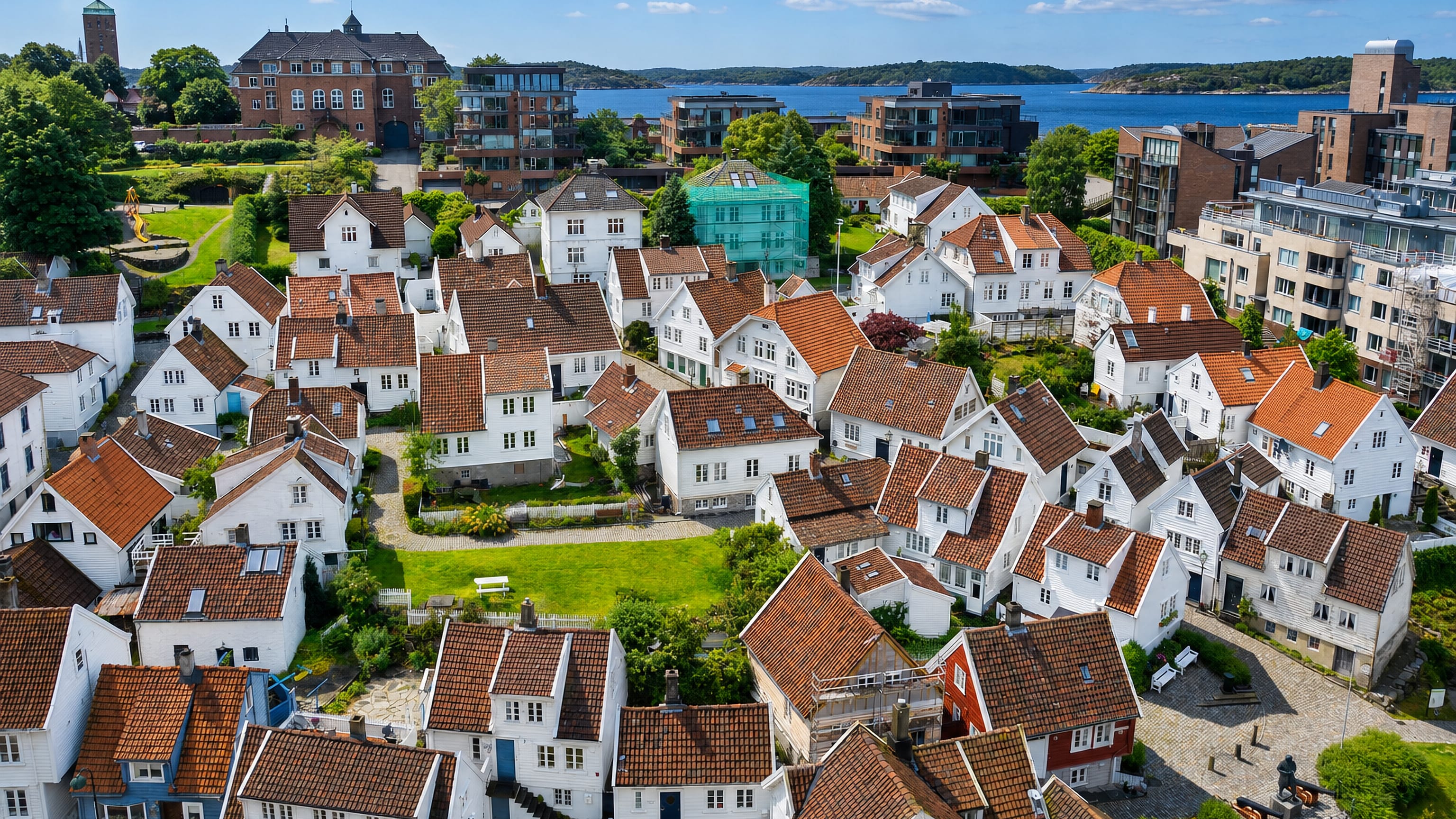 Aerial view of Straen's white timber houses and tiled roofs above the water in Stavanger