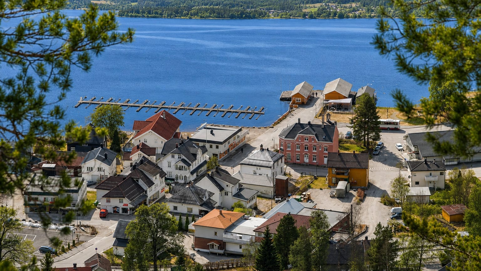 Lakeside village of Kviteseid, Norway, with jetties and timber buildings framed by pines above the water