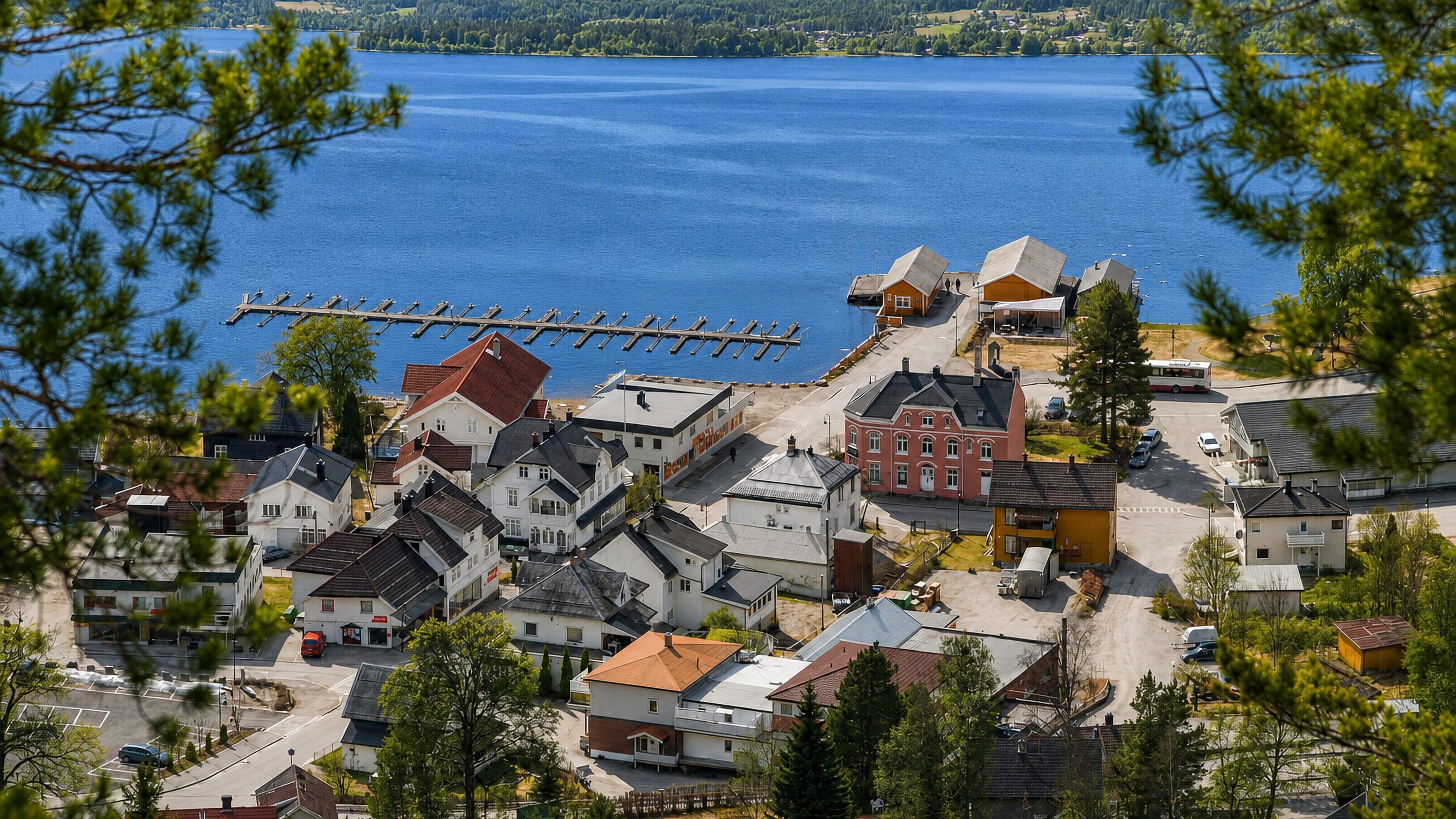 Lakeside village of Kviteseid, Norway, with jetties and timber buildings framed by pines above the water