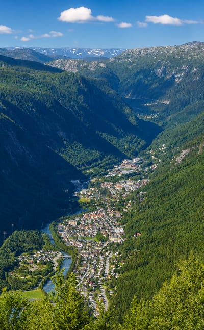 Aerial view of Rjukan strung along the valley floor of steep, forested Vestfjorddalen in Telemark