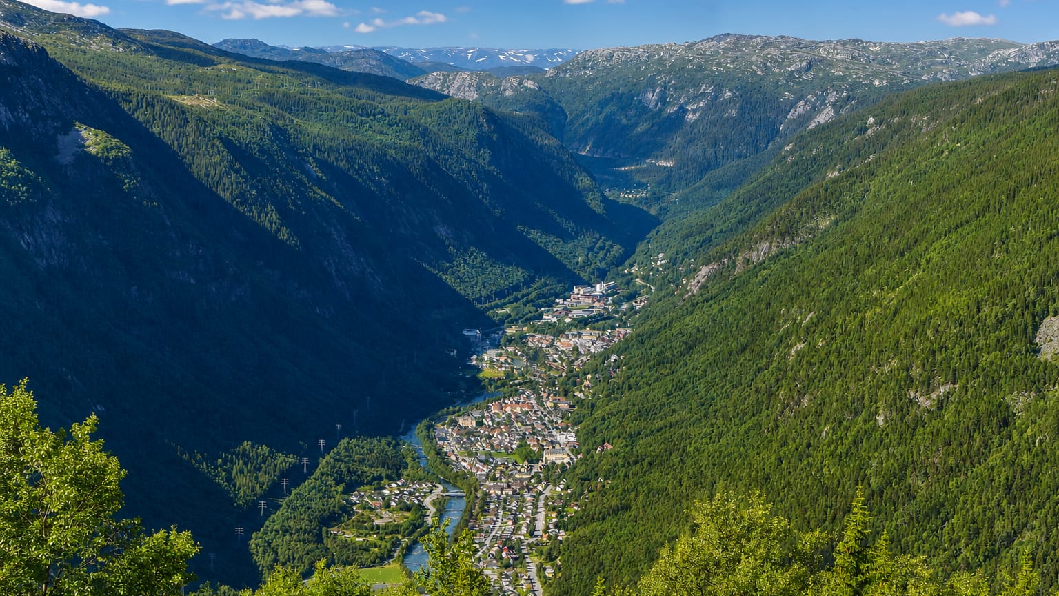 Aerial view of Rjukan strung along the valley floor of steep, forested Vestfjorddalen in Telemark