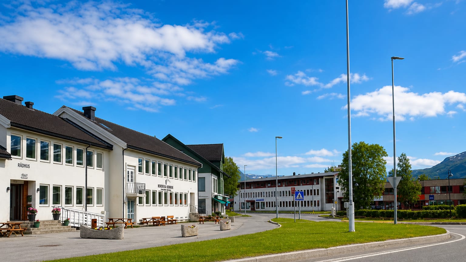 Storslett town centre with the Nordreisa municipality hall and Rådhus below distant mountains, Norway.