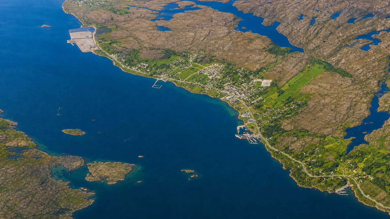 Aerial view of the island settlement of Sistranda, Norway, scattered across rocky coastal terrain among blue waters