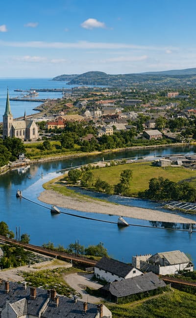 Elevated daytime view over Byåsen, Norway, with a river bending past a church spire toward the fjord and distant hills