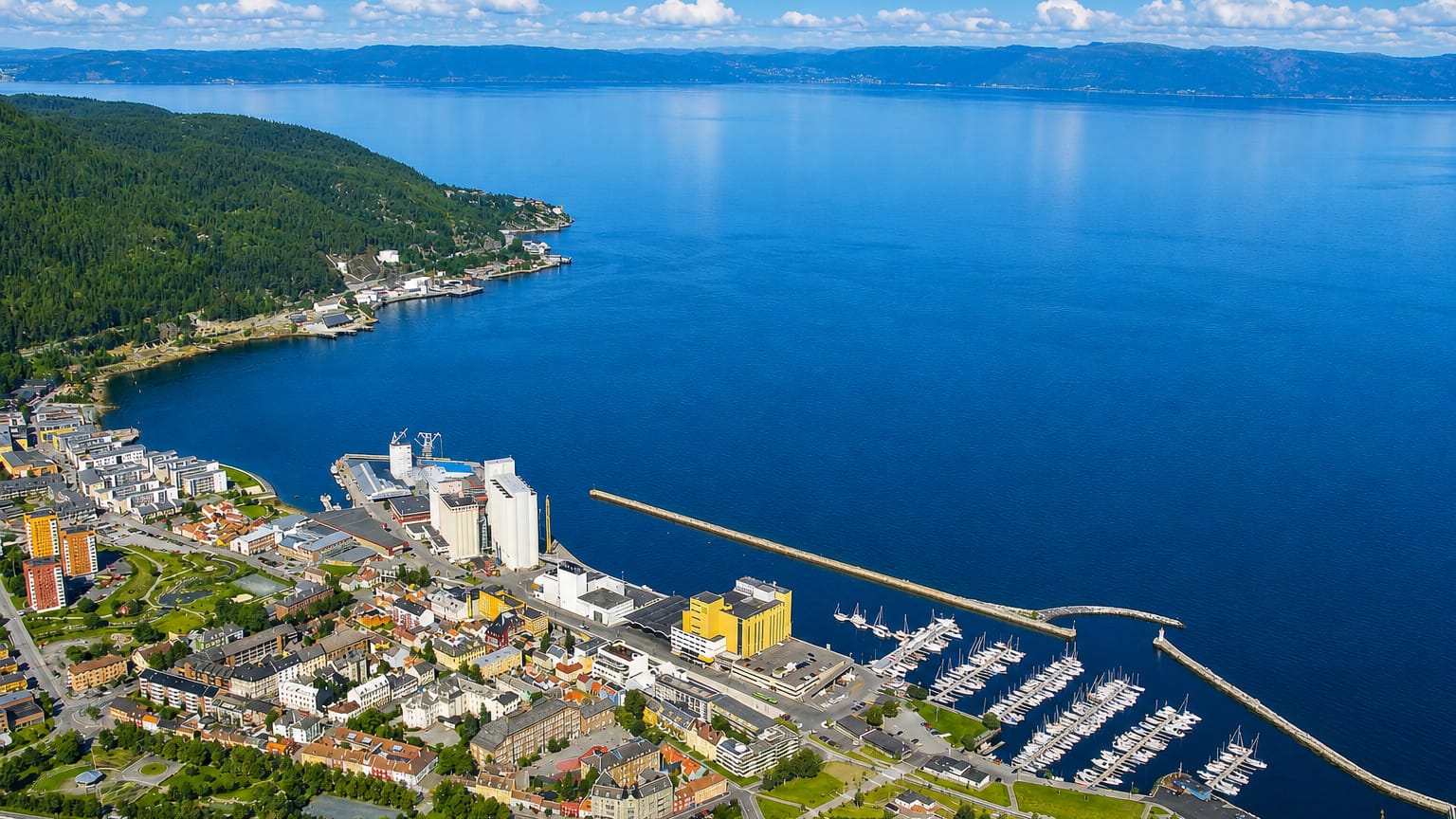 Aerial daytime view of Ila in Trondheim, Norway, with its harbour, marina and grain silos along the blue Trondheimsfjord.