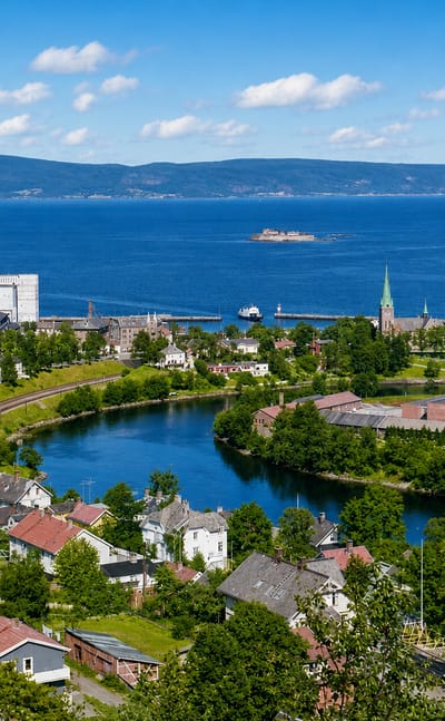 Elevated daytime view over Øya in Trondheim, Norway, with the Nidelva river loop, fjord and Munkholmen island beyond