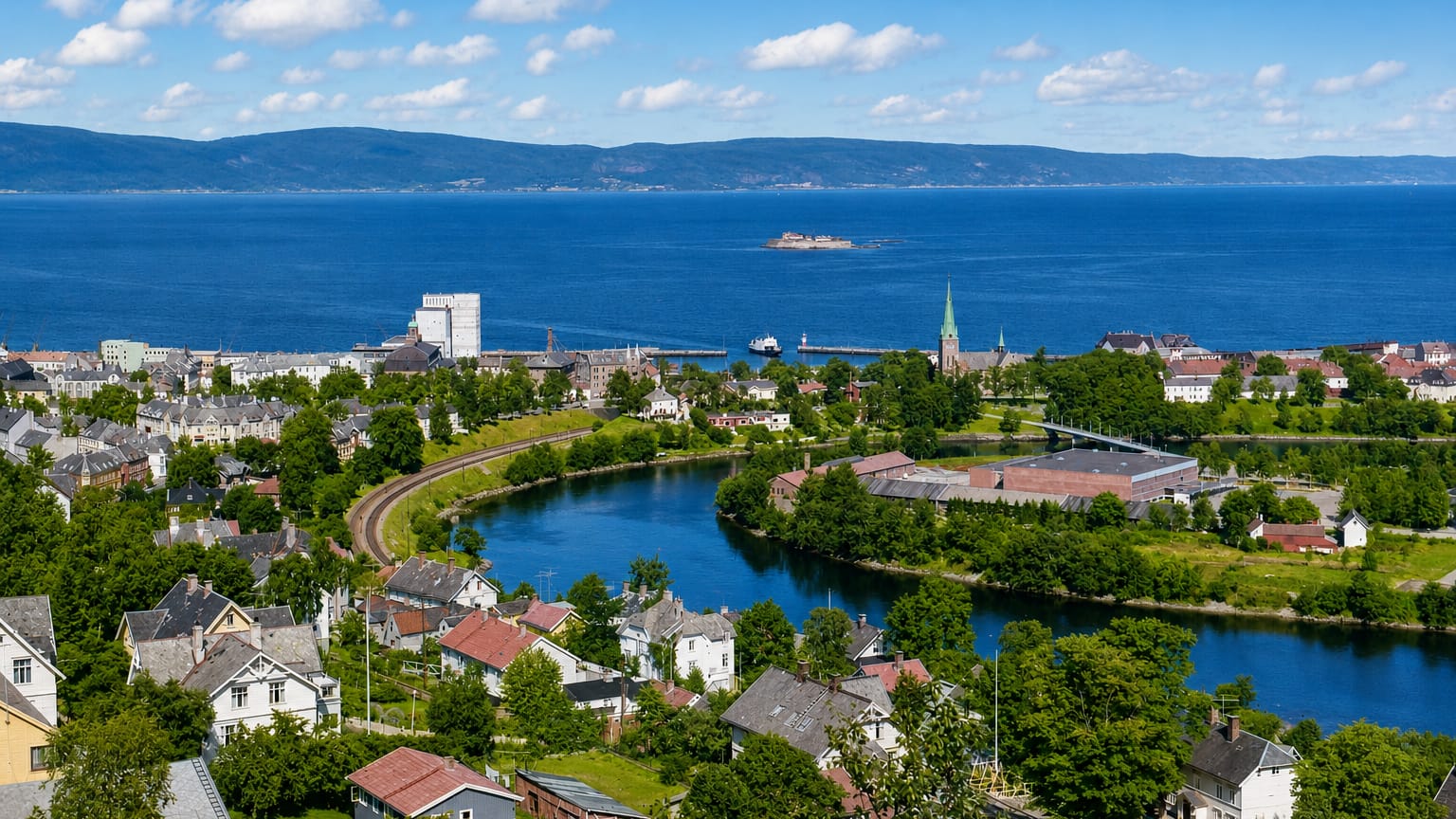 Elevated daytime view over Øya in Trondheim, Norway, with the Nidelva river loop, fjord and Munkholmen island beyond