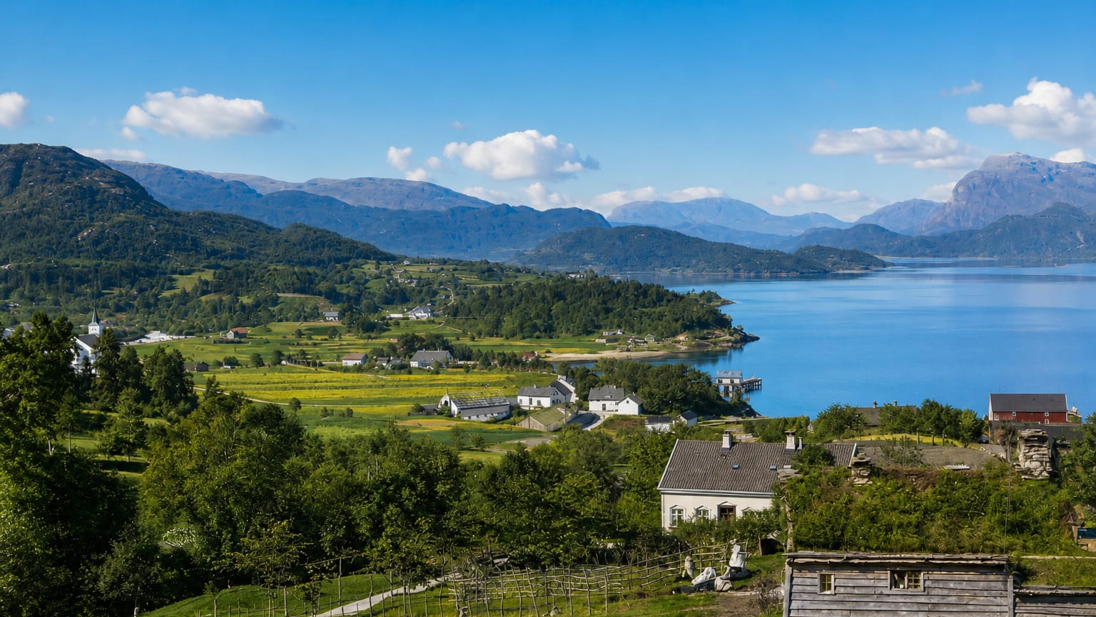 Dale in Fjaler, Norway: white farmhouses and turf-roofed cabin on green slopes above the blue Dalsfjorden and mountains