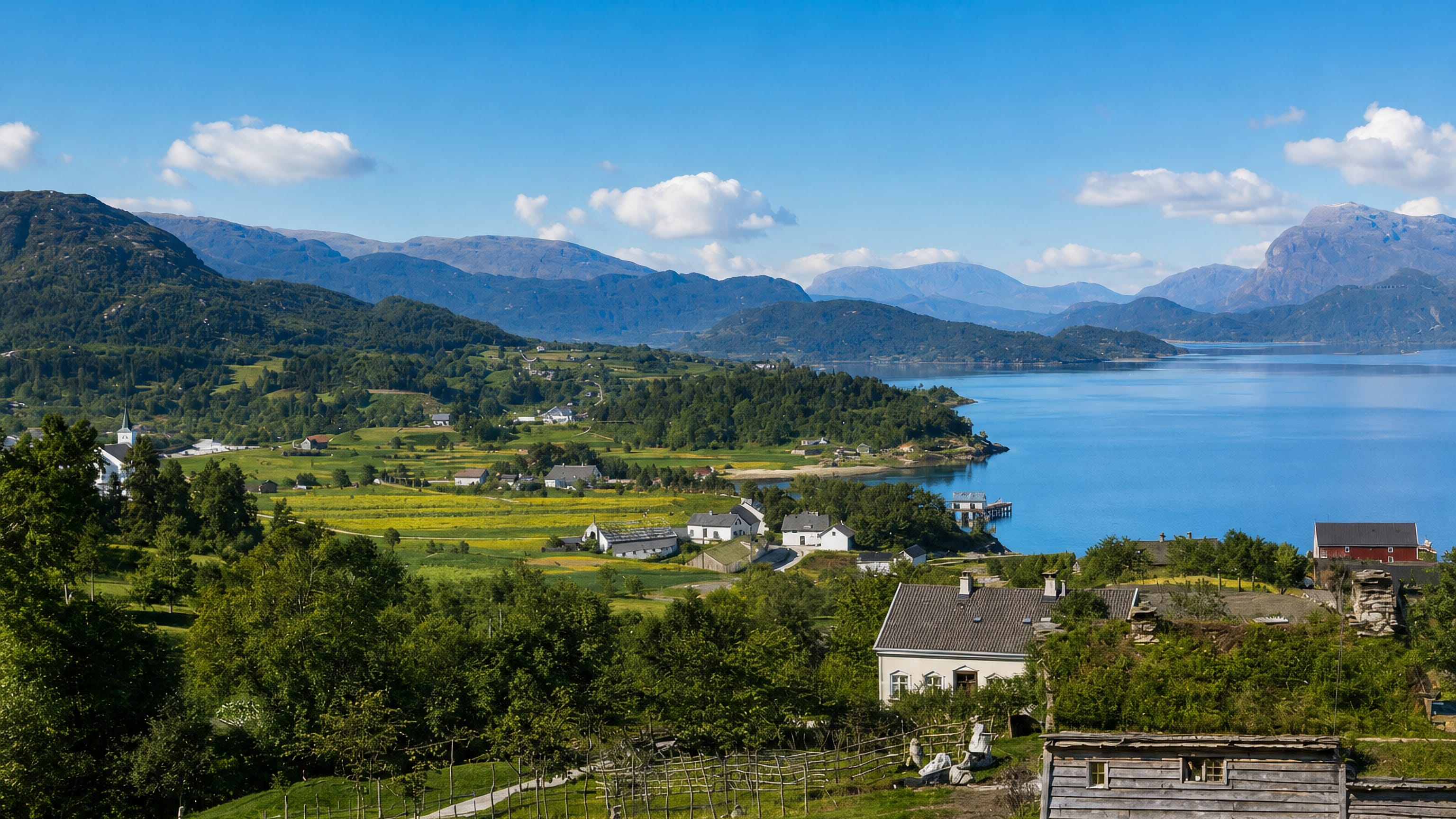 Dale in Fjaler, Norway: white farmhouses and turf-roofed cabin on green slopes above the blue Dalsfjorden and mountains