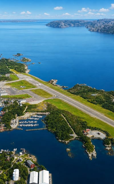 Aerial view of Floro on the Norwegian coast with its airport runway, harbour and skerry-dotted fjord.