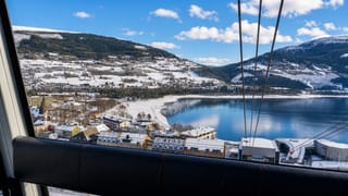 Winter view over Voss and Vangsvatnet lake from the Voss gondola, with snow-covered town and mountains.