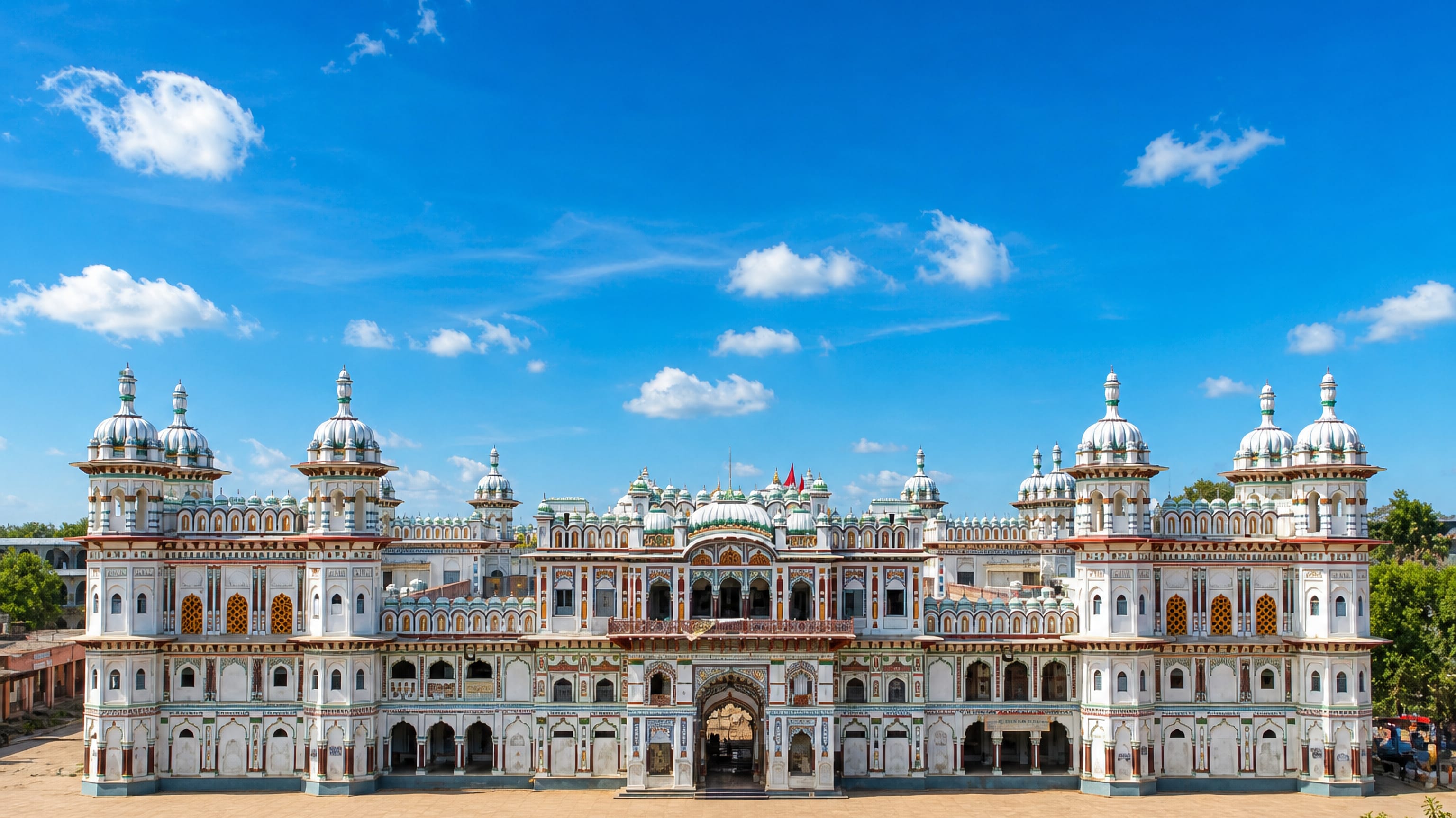 The white marble Janaki Mandir temple and its domed towers in Janakpur, Nepal, under a clear blue sky