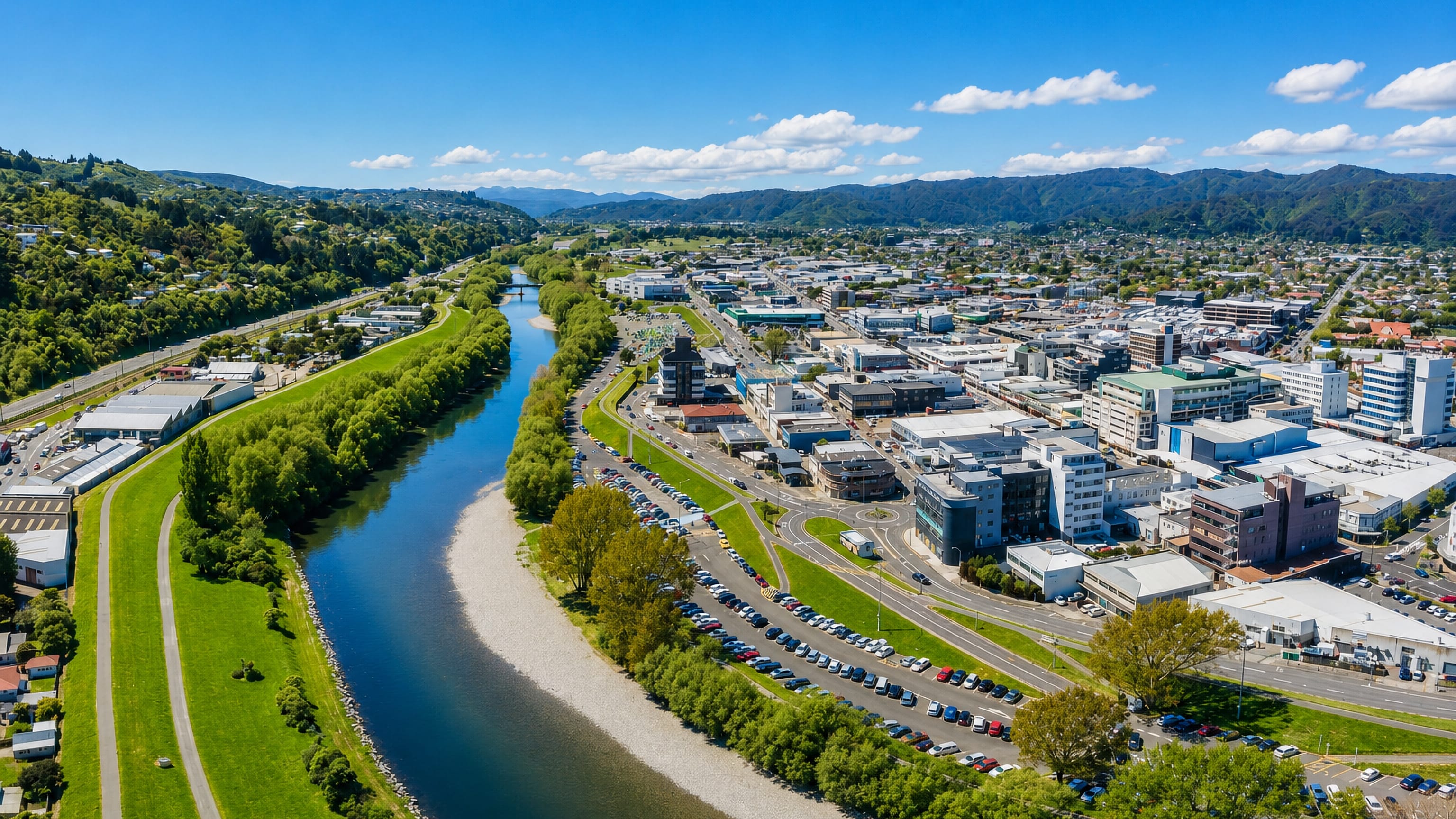 The Hutt River curving past the low-rise centre of Lower Hutt, with the Wellington hills rising behind