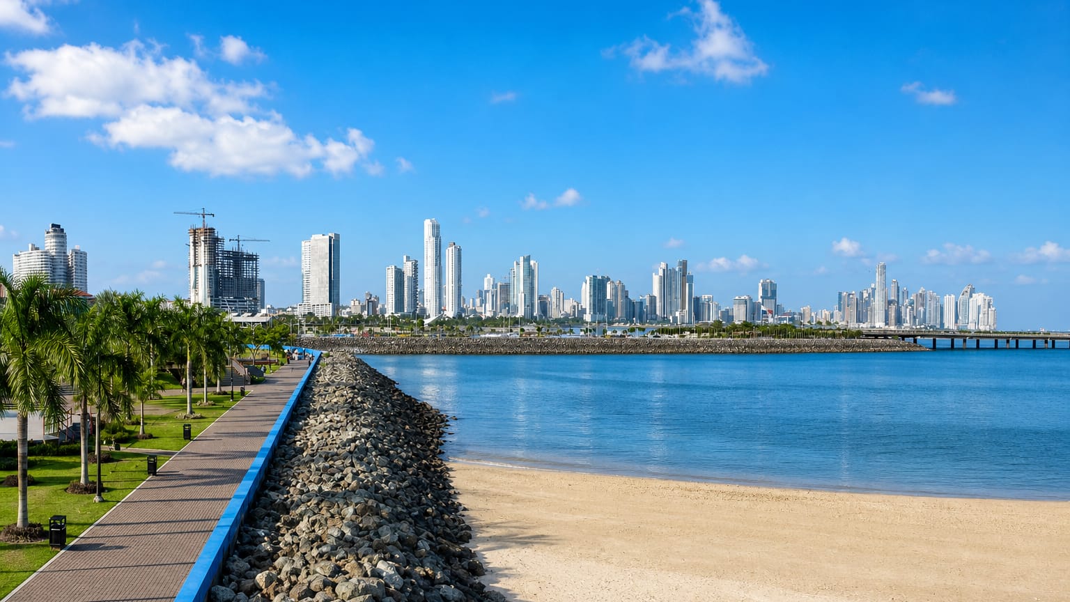 Panama City's modern skyline across the bay from the palm-lined Cinta Costera waterfront promenade.
