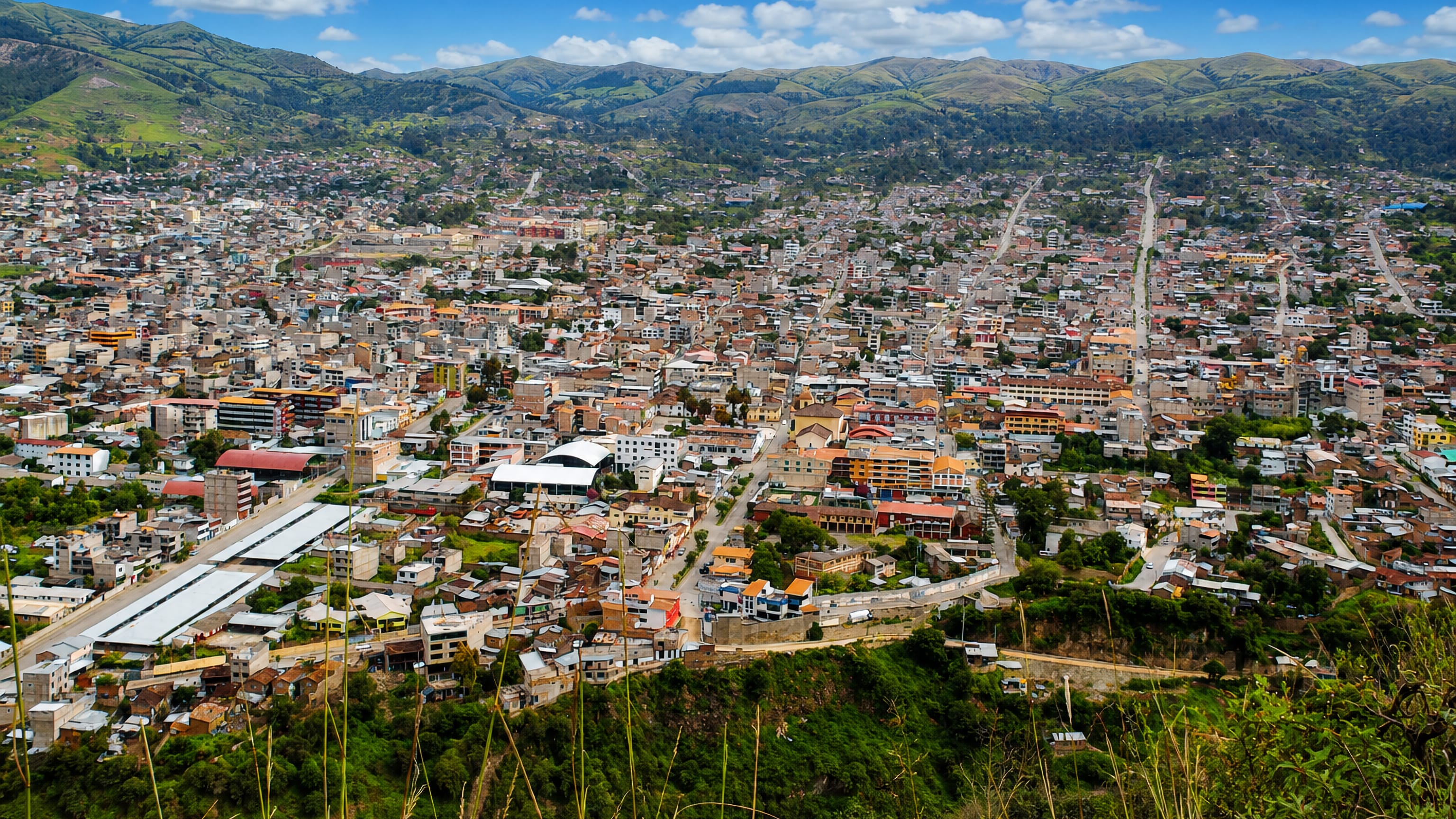 Abancay's dense red-roofed streets fill an Andean valley ringed by green mountains in southern Peru.