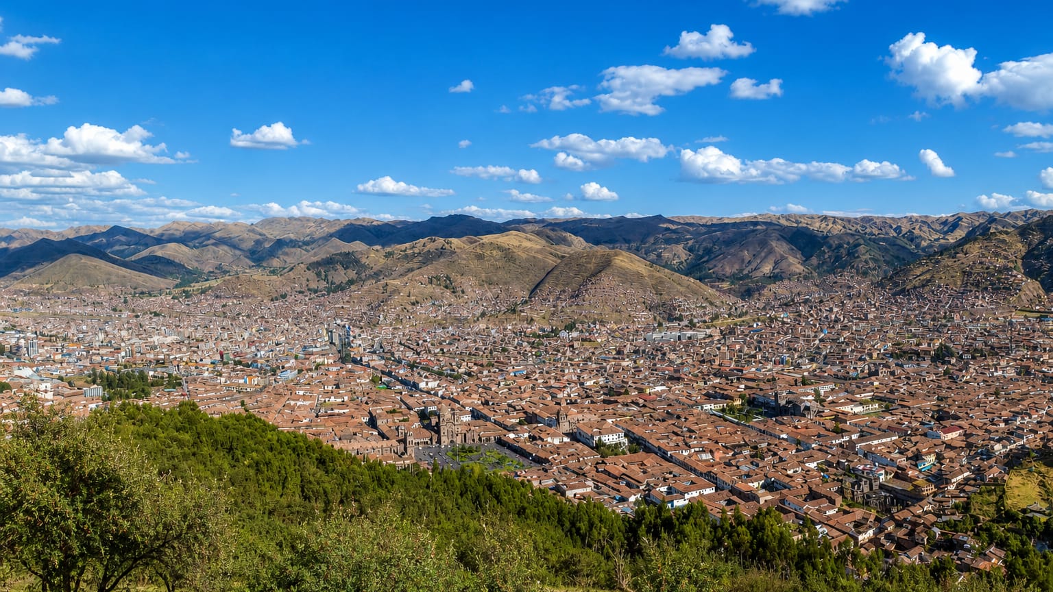 Cusco's red-tiled old town filling the Andean valley seen from a hillside, Peru