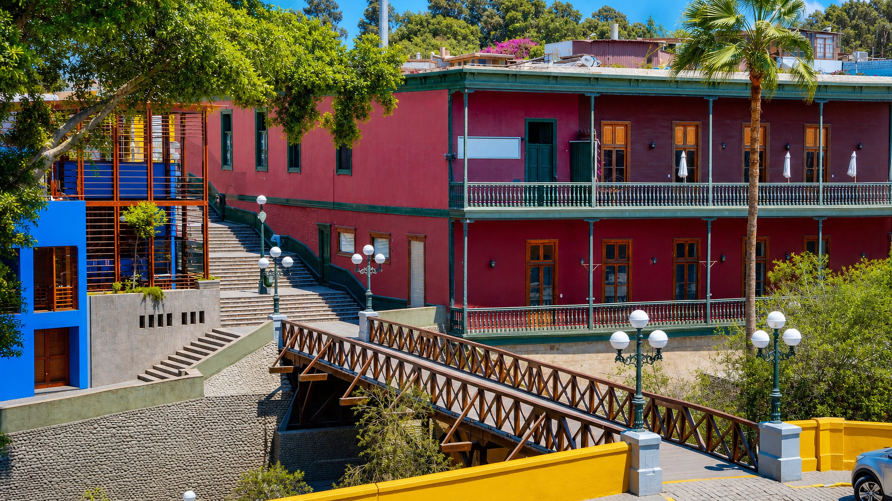 The wooden Bridge of Sighs and a crimson balconied casona above the Bajada de Baños in Barranco, Lima.