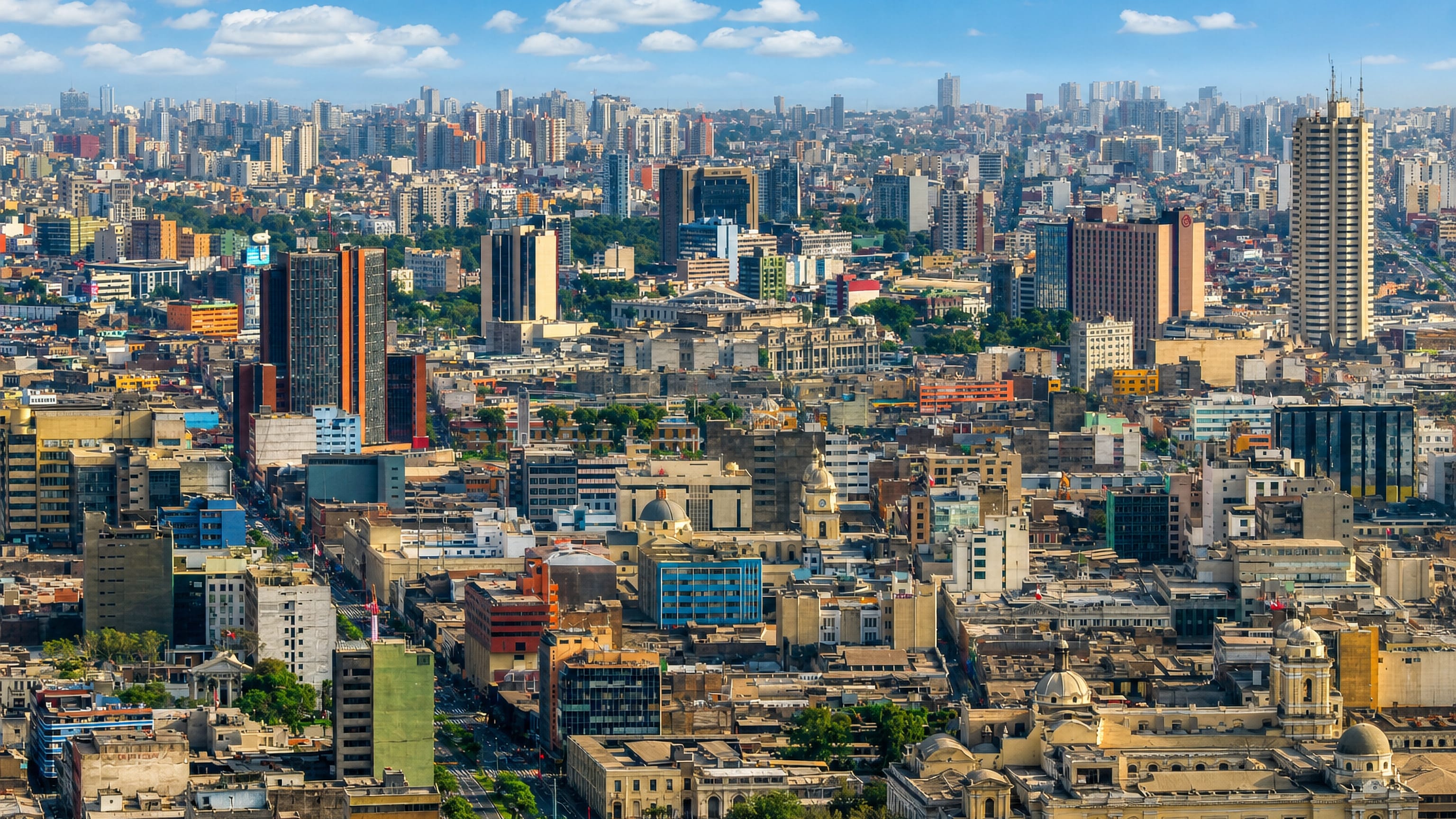Dense daytime skyline of central Lima with high-rises and historic buildings under a blue sky