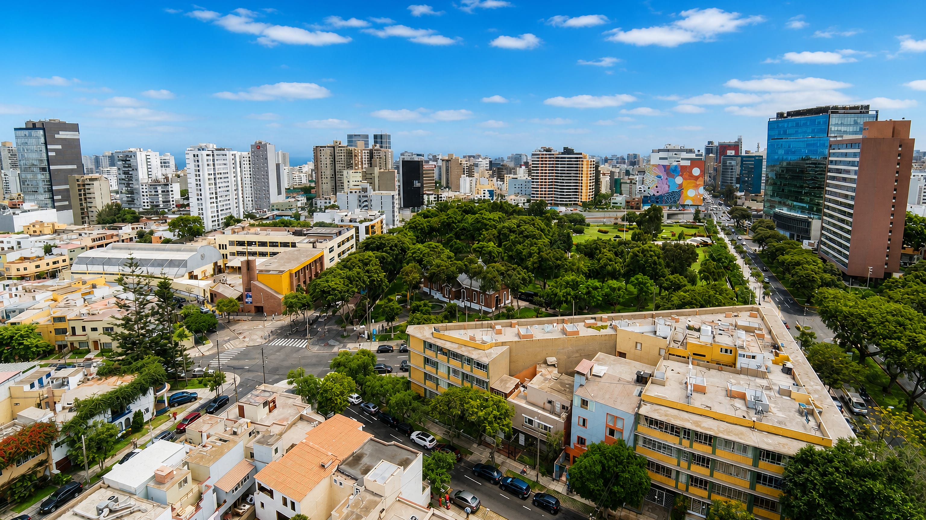Aerial view of Miraflores in Lima, its central park ringed by apartment towers with the Pacific beyond.