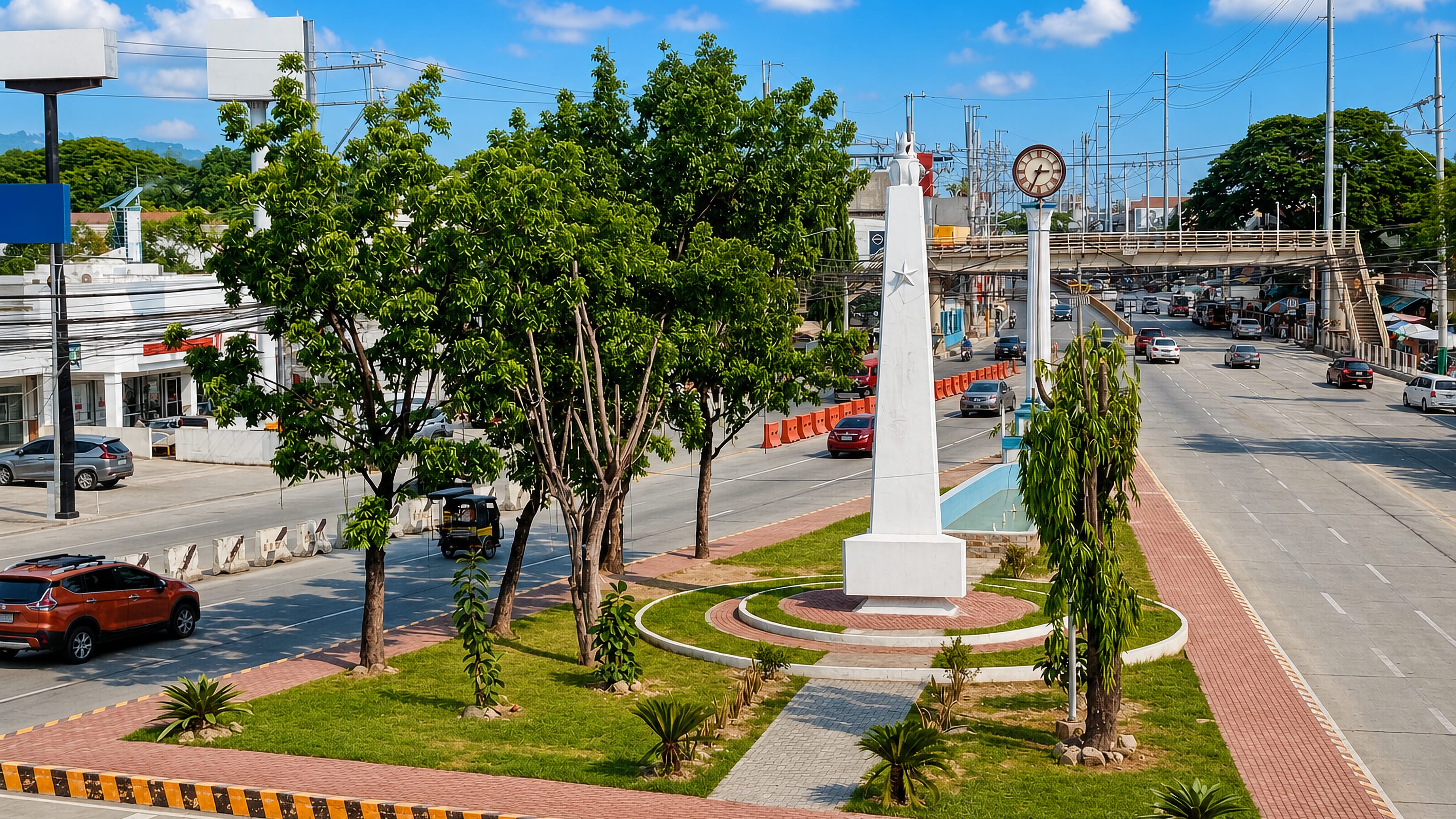 Obelisk monument and street clock on a landscaped highway median in Taytay, with tricycles and a footbridge behind.