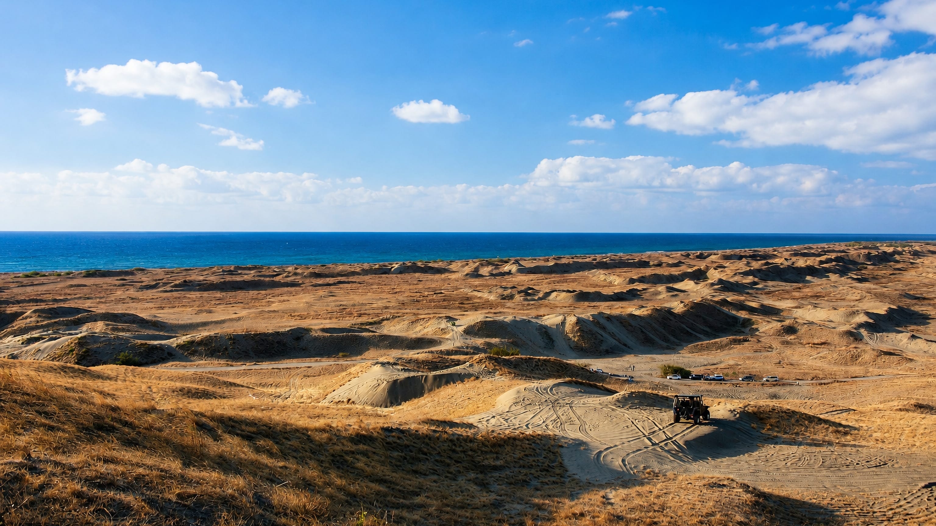 Rolling coastal sand dunes meeting the sea at La Paz near Laoag, Ilocos Norte, Philippines.