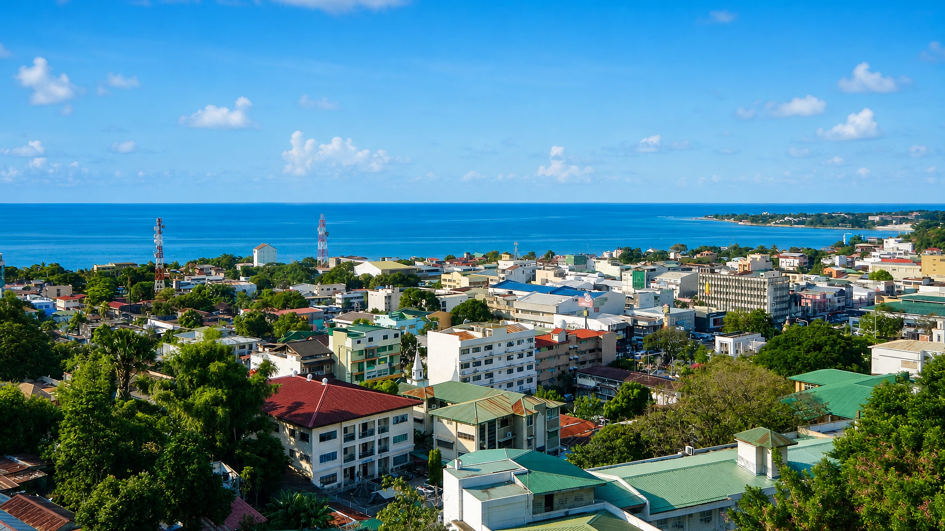 Rooftops of San Fernando, La Union, spread toward the coastline and open sea in the Philippines.