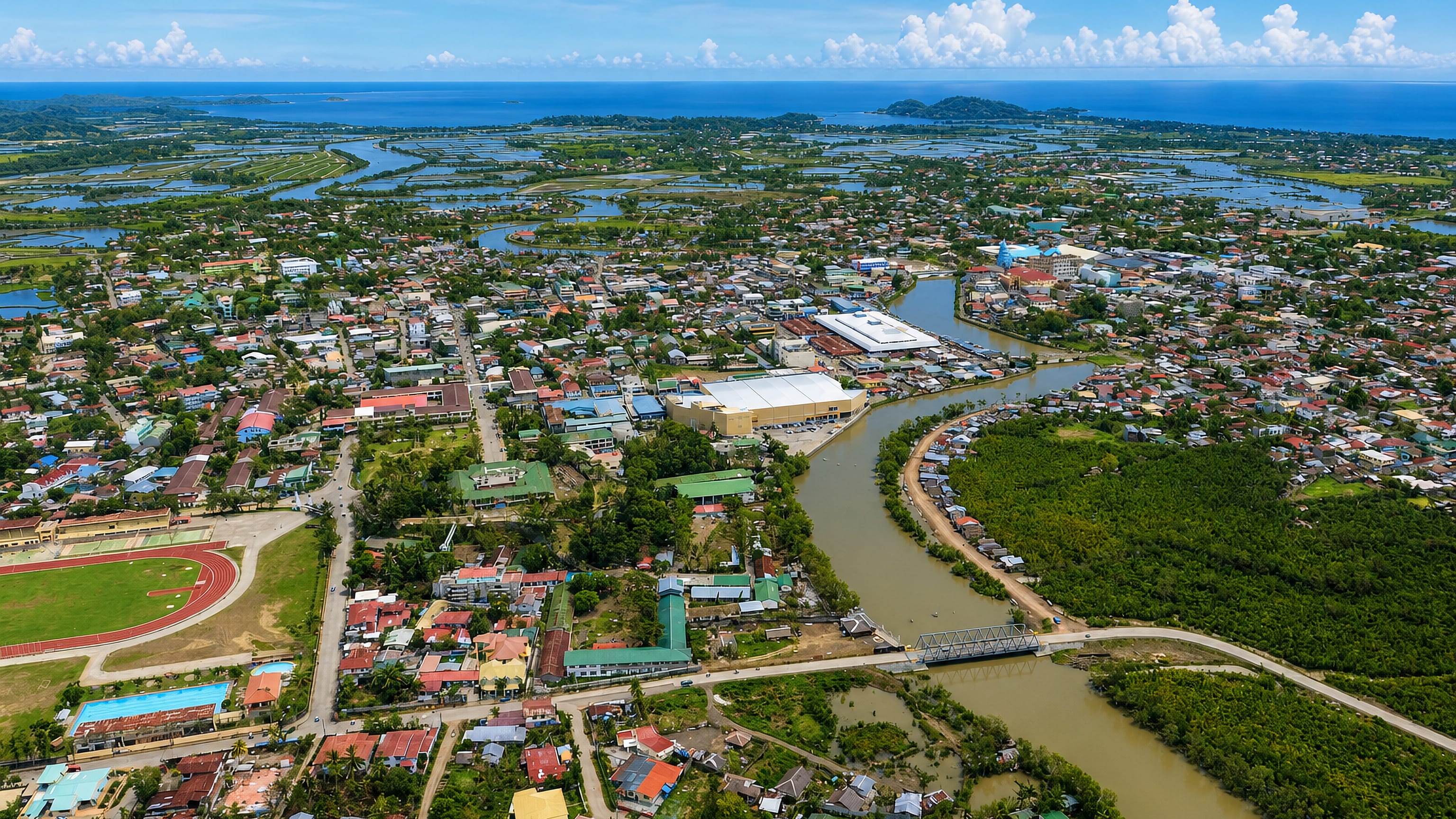 Roxas City on Panay, its river winding past rooftops and fishponds out to the sea beyond.