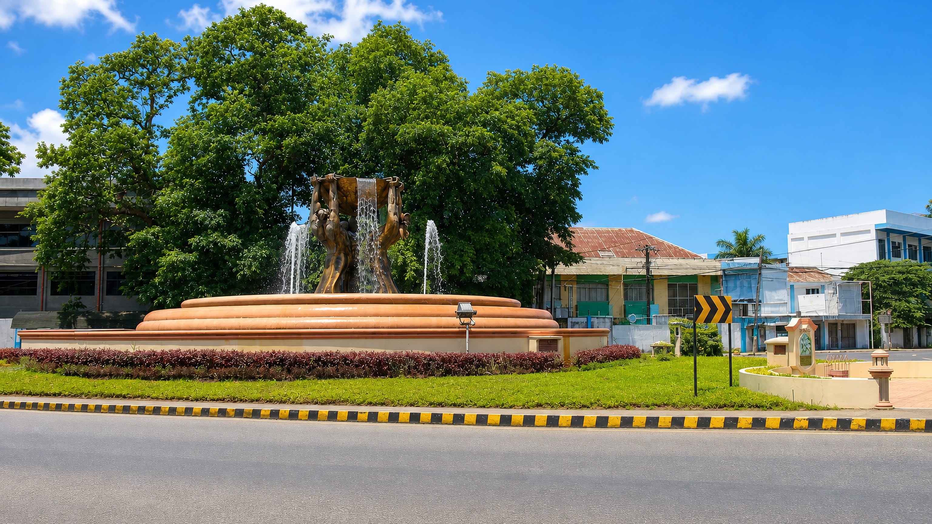 Fountain roundabout with sculpted figures on a main road through Dipolog, Zamboanga Peninsula.