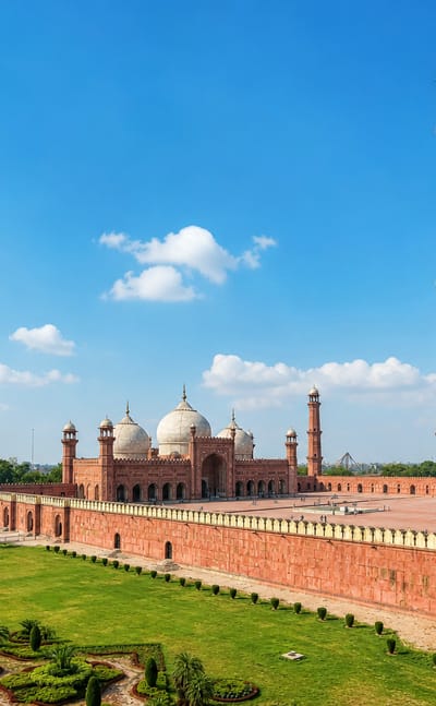 The red sandstone Badshahi Mosque with its minarets and white domes in the Walled City of Lahore