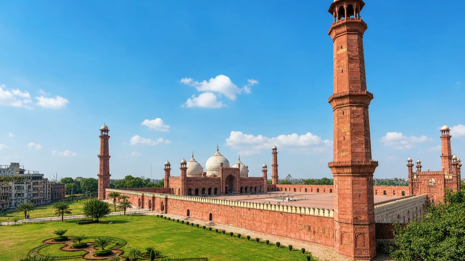 The red sandstone Badshahi Mosque with its minarets and white domes in the Walled City of Lahore