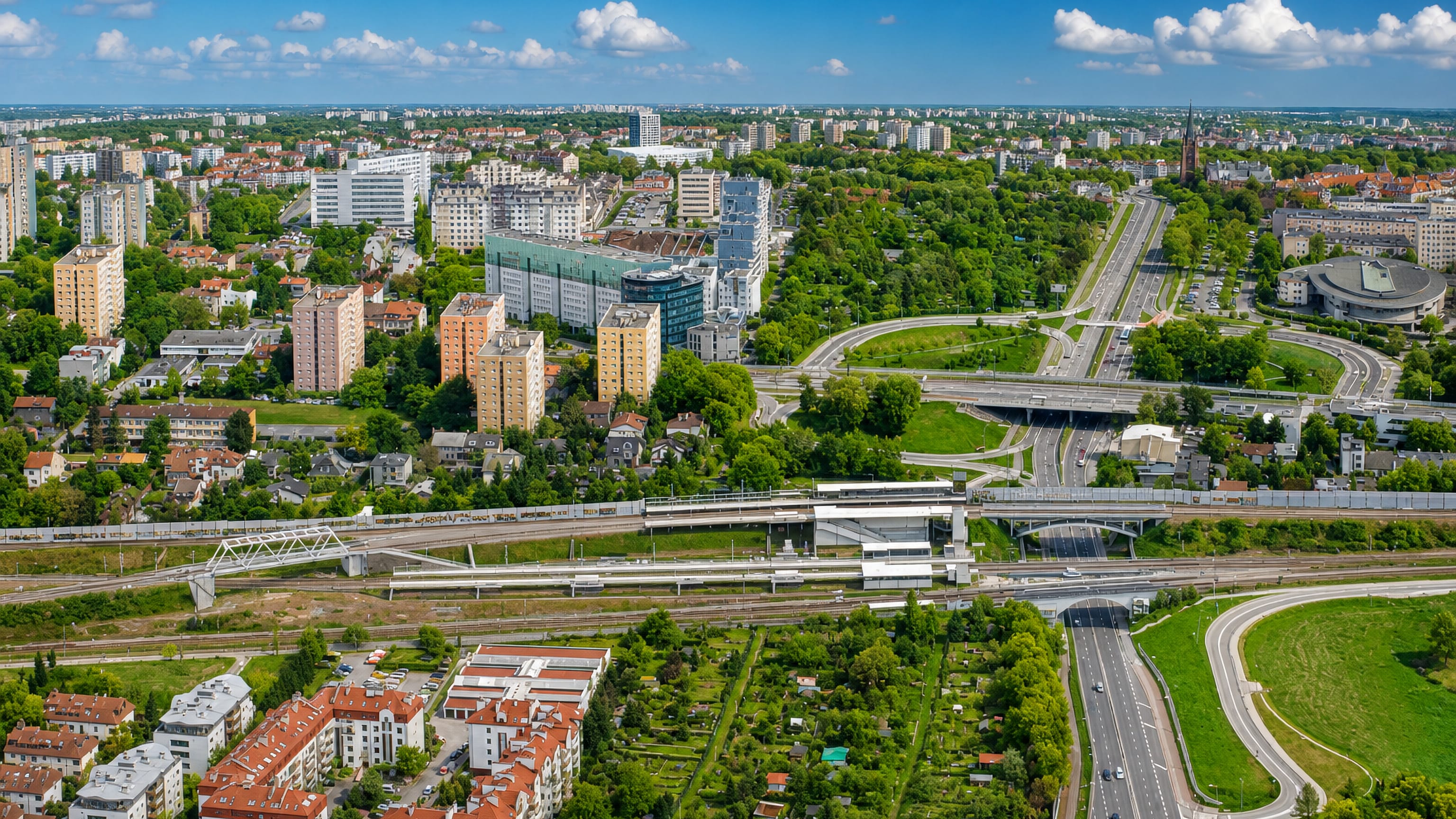 Aerial view of Bronowice in Krakow, with a railway line, motorway junction, allotments and housing blocks