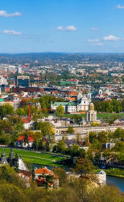 Panorama of Krakow from Debniki across the Vistula River showing the old town, church domes and a tourist balloon