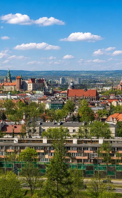 Kraków panorama from Podgórze with Wawel Castle on the skyline above green-roofed housing