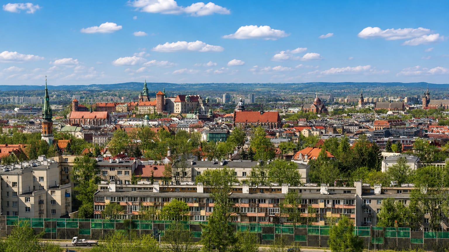 Kraków panorama from Podgórze with Wawel Castle on the skyline above green-roofed housing