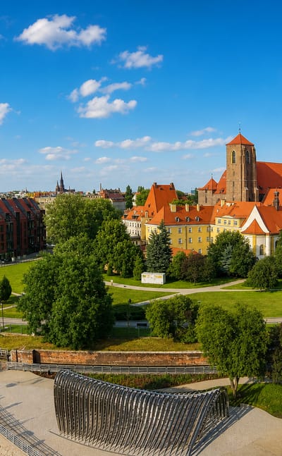 Wroclaw's Ostrow Tumski with red-brick Gothic churches and townhouses along the Oder river amid greenery